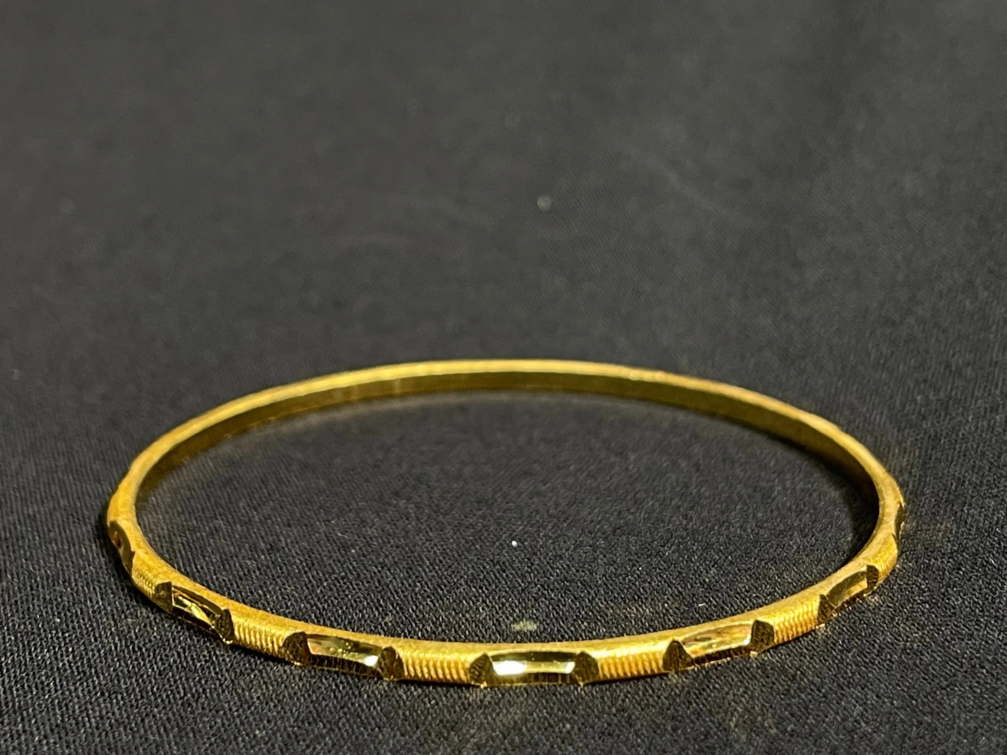 Palestinian Elegance imitated gold Karmela Thin Bangles with geometric cutout design on black background