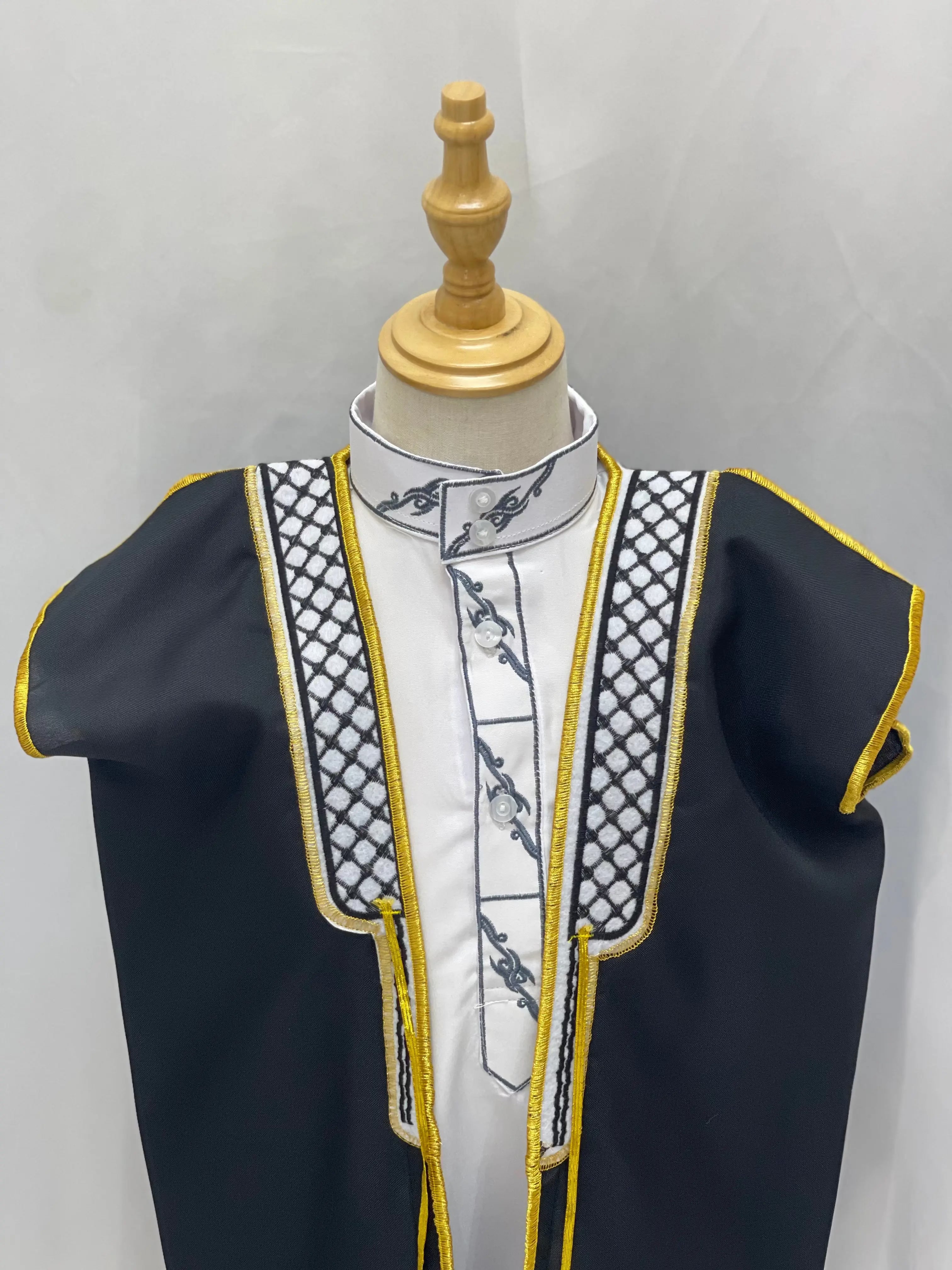 Palestinian Elegance Kids Kuffiyeh Bisht in black with white and gold embroidered trim on a mannequin