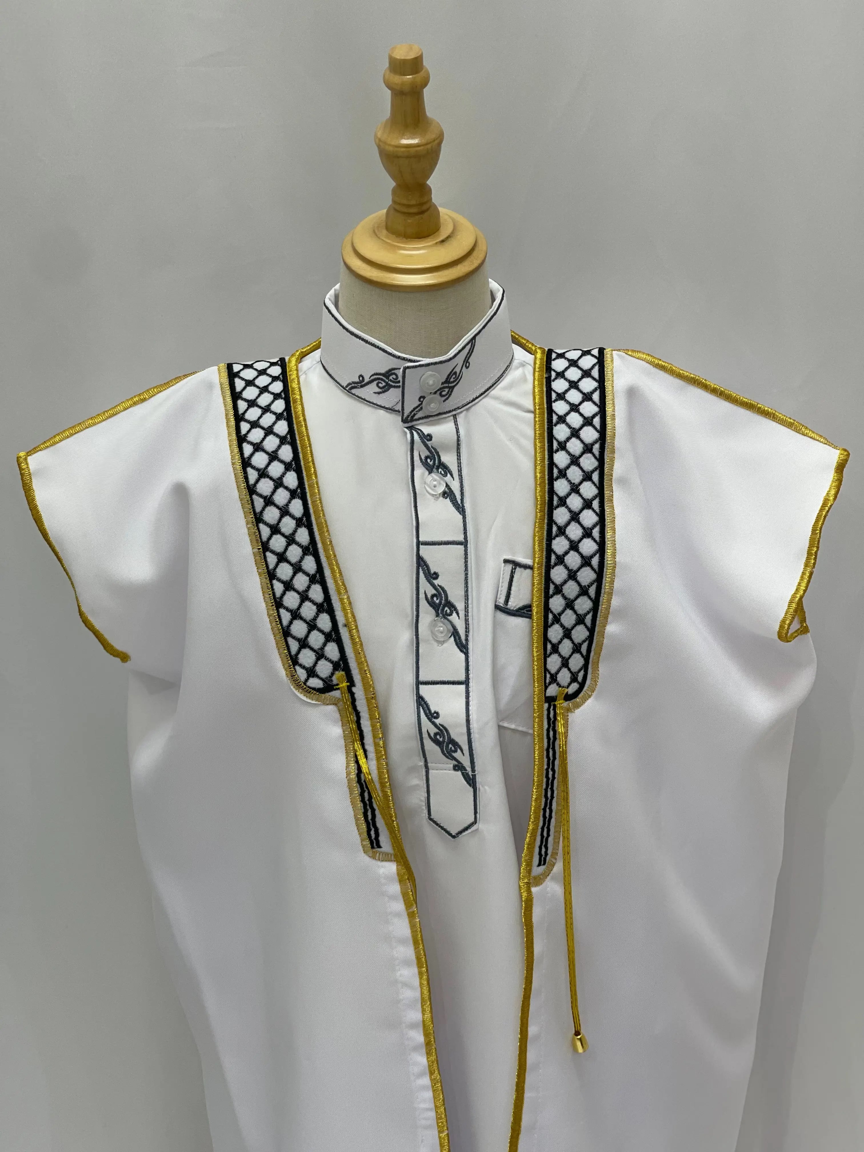 White Kids Kuffiyeh Bisht with black embroidery and gold trim on a mannequin by Palestinian Elegance