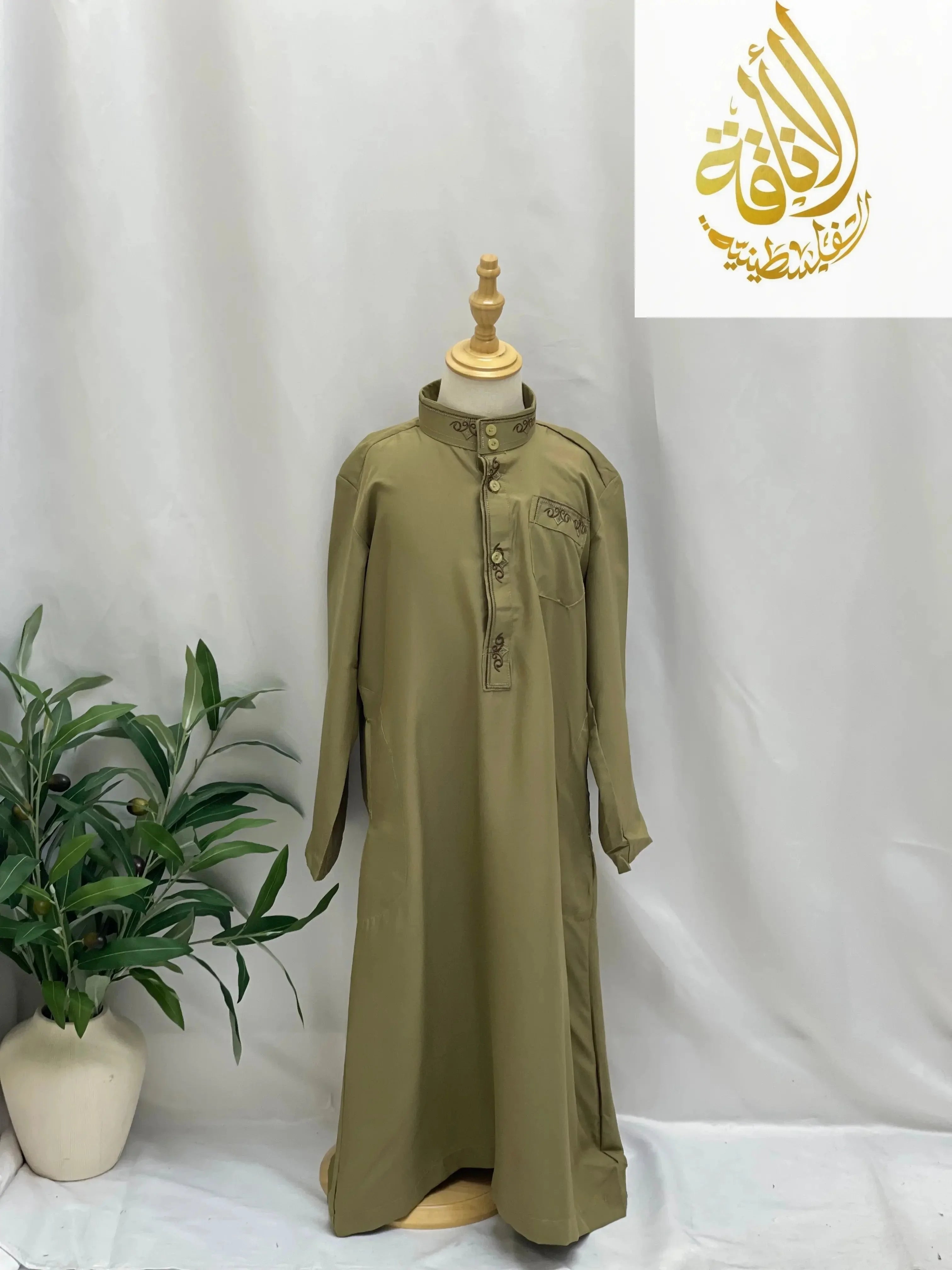 Palestinian Elegance kids embroidered thobe in olive green displayed on a wooden mannequin
