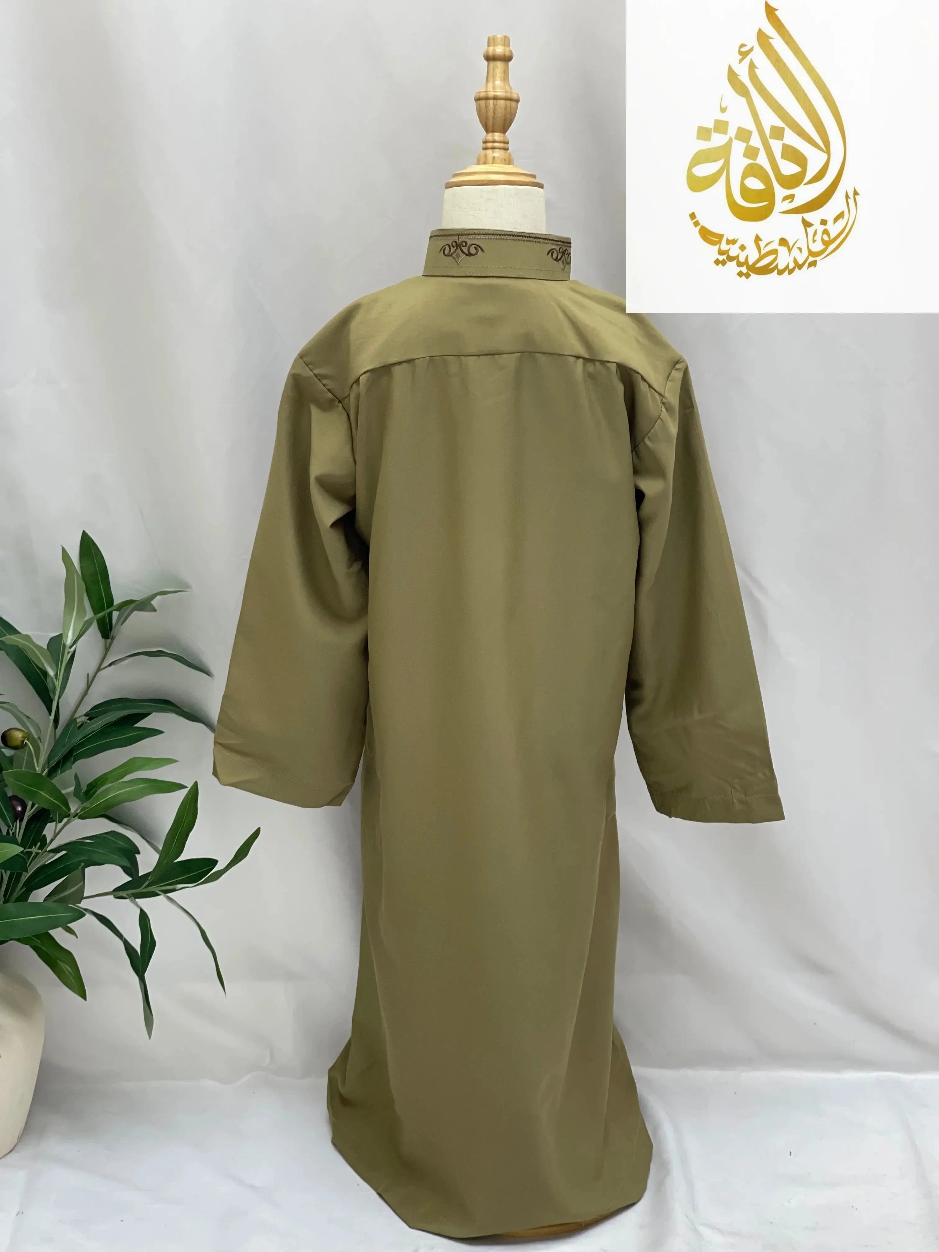 Back view of olive green kids embroidered thobe by Palestinian Elegance on mannequin with decorative collar
