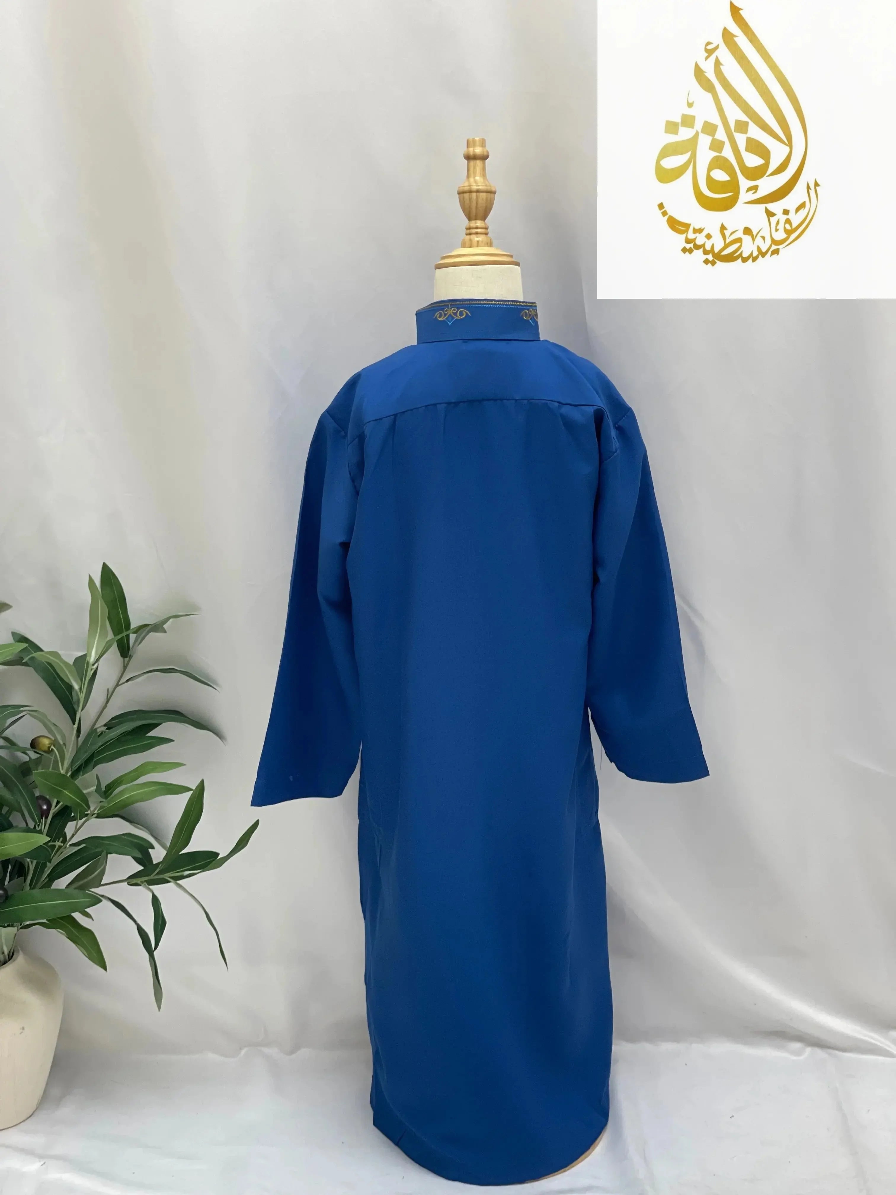 Back view of a blue kids embroidered thobe on a mannequin from Palestinian Elegance