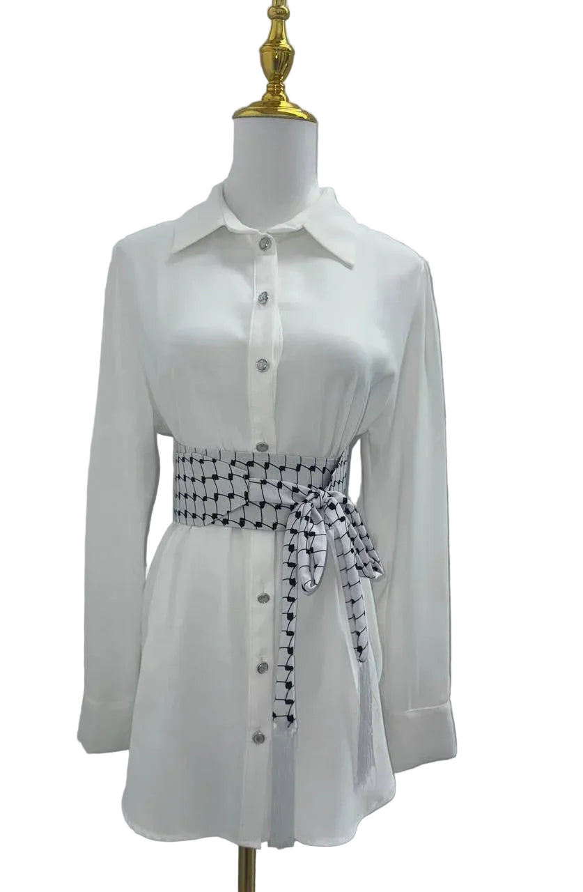 Kufiya Identity Belt in black and white design, styled on a white button-up shirt for a chic look