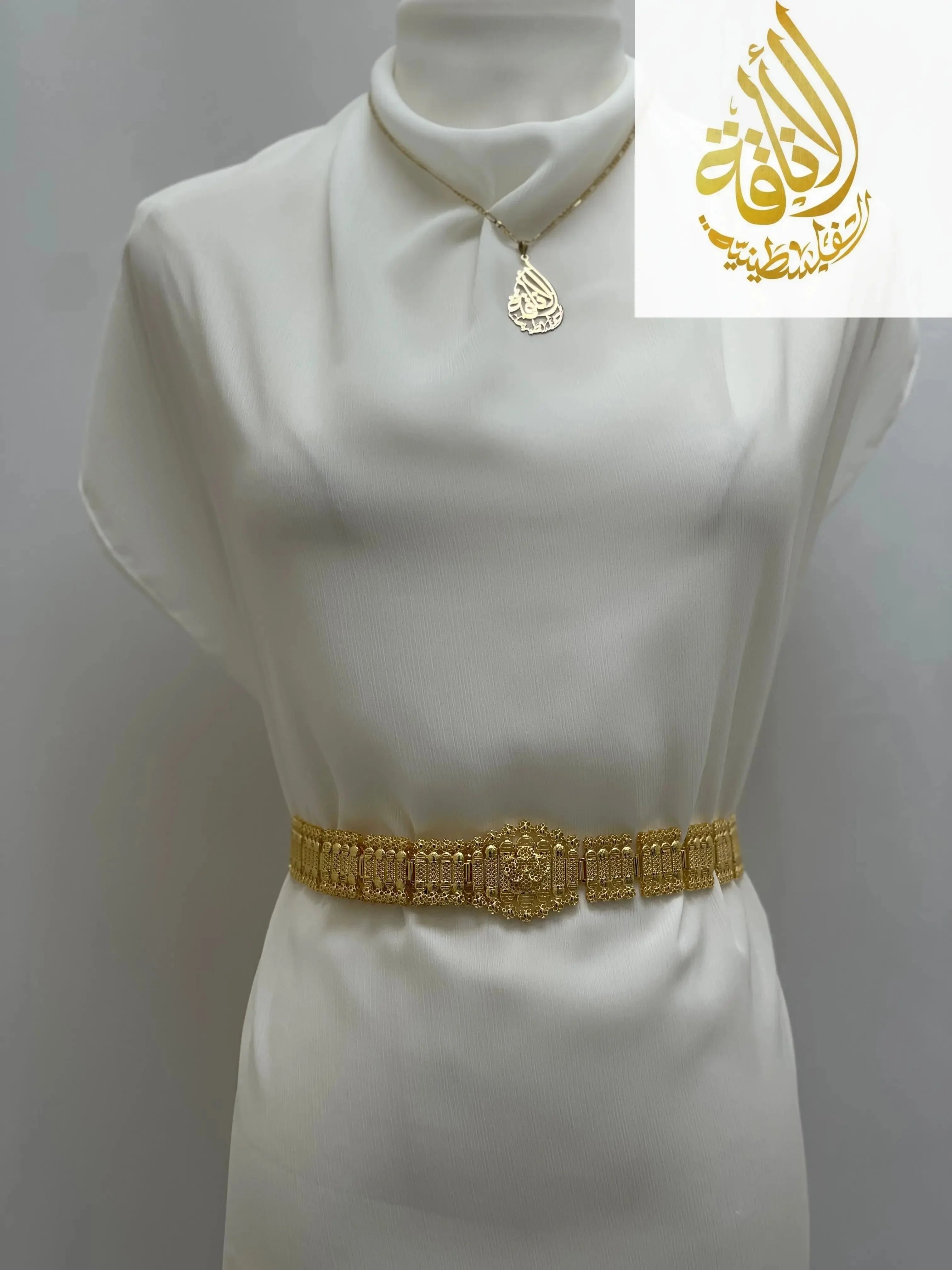 Kurdish gold style belt by Palestinian Elegance displayed on white fabric mannequin