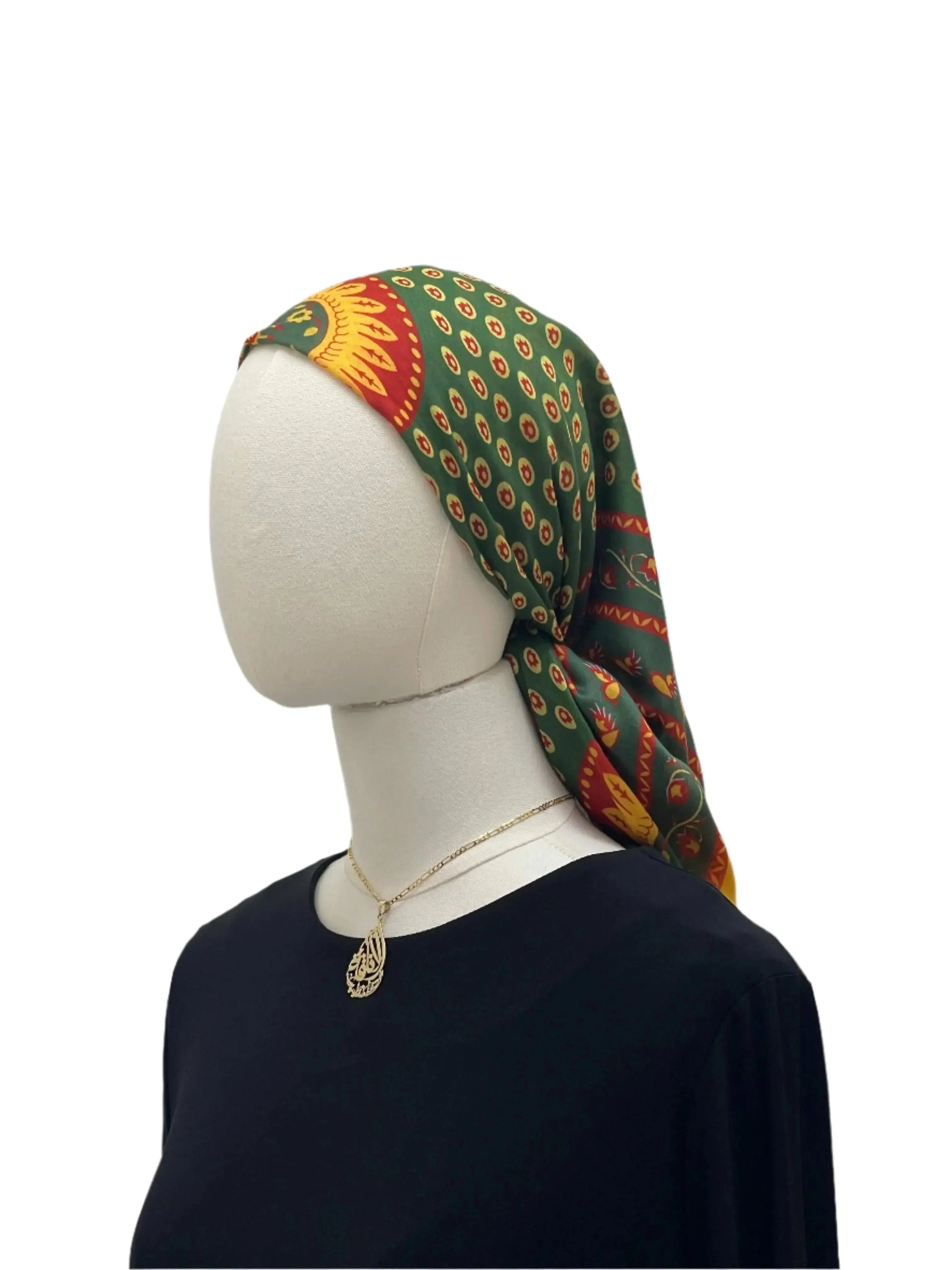 Palestinian Elegance Large Square Siti Asba hijab in green with intricate red and yellow pattern