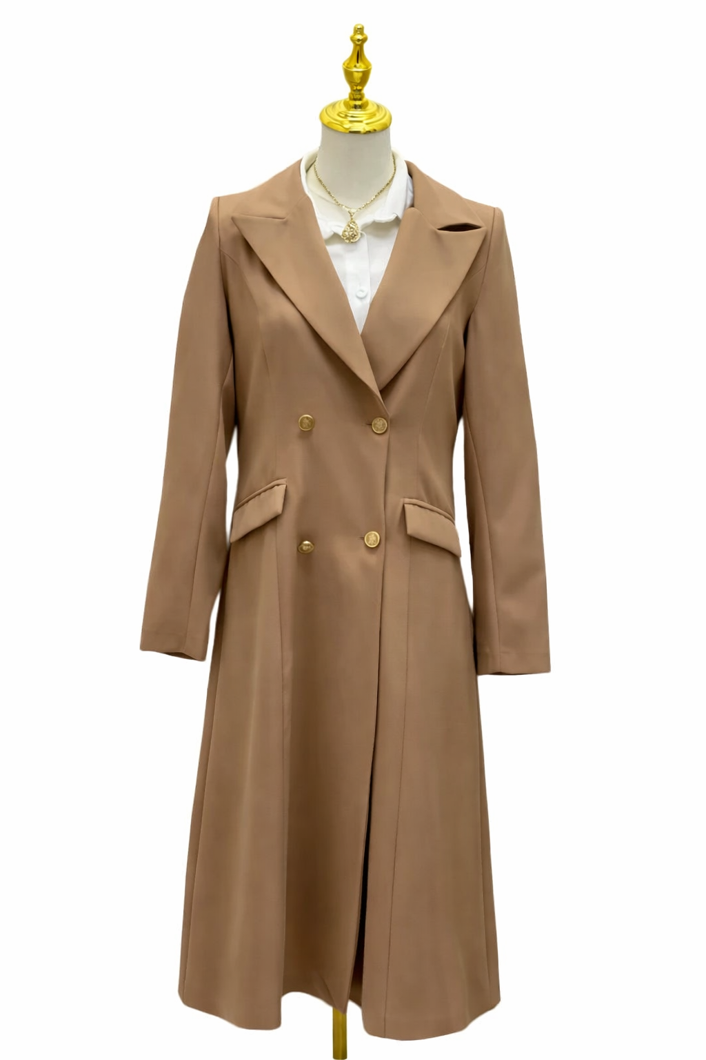 Beige trench coat on a mannequin with a white shirt underneath against a white background