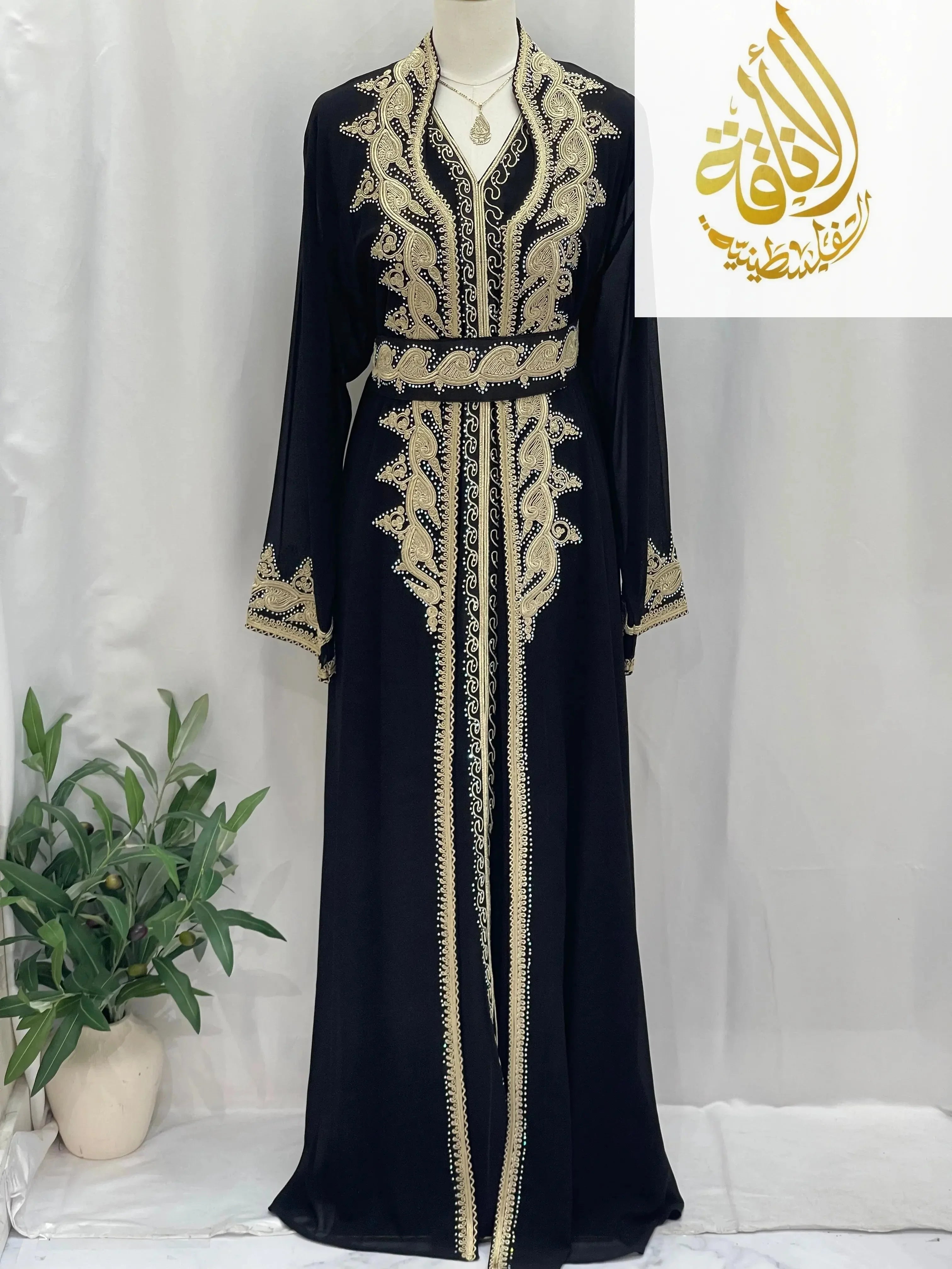 Palestinian Elegance luxurious Alamera kaftan in black with intricate gold embroidery and matching belt