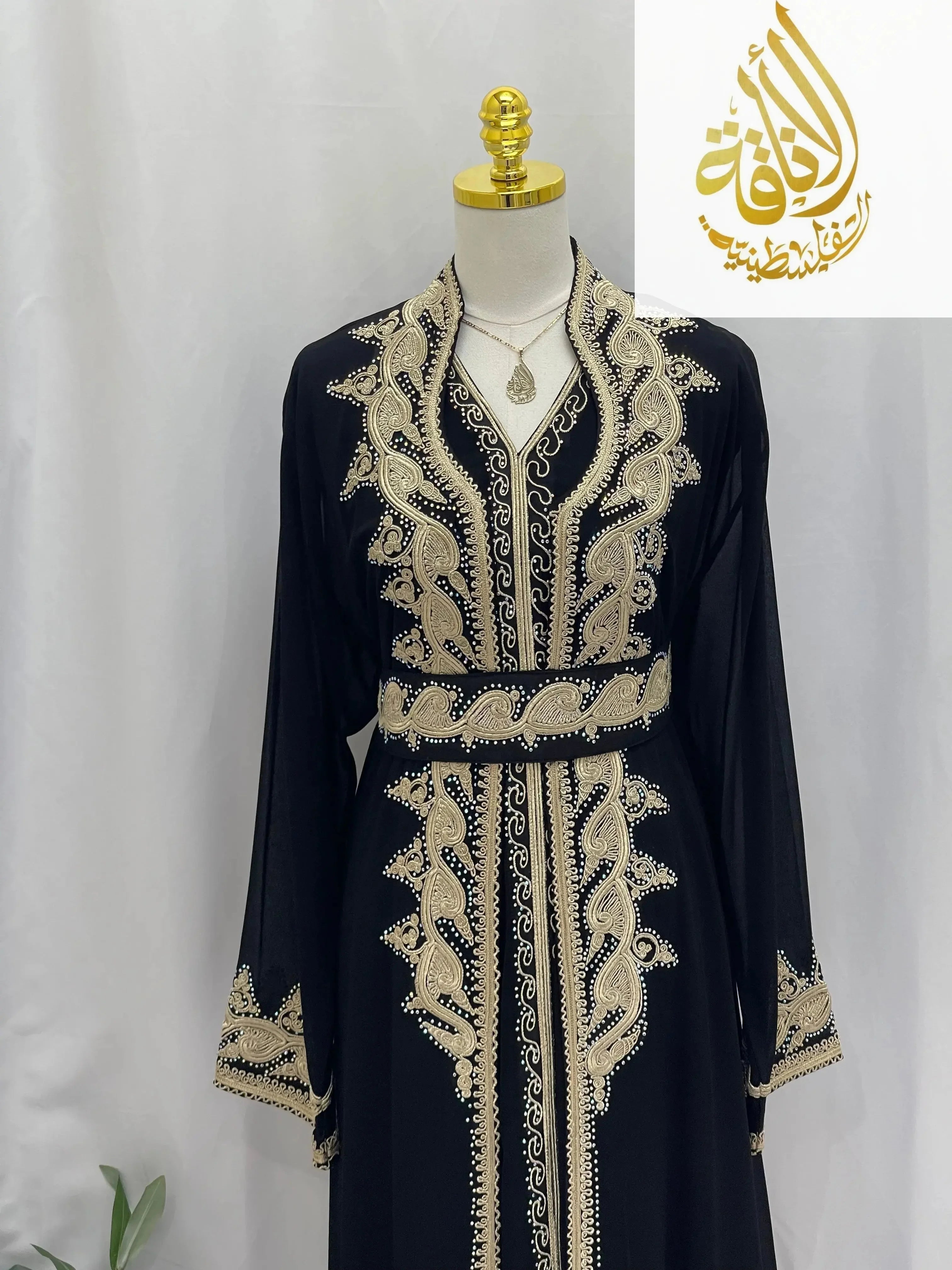 Palestinian Elegance black kaftan with intricate gold embroidery featuring luxurious Alamera kaftan design