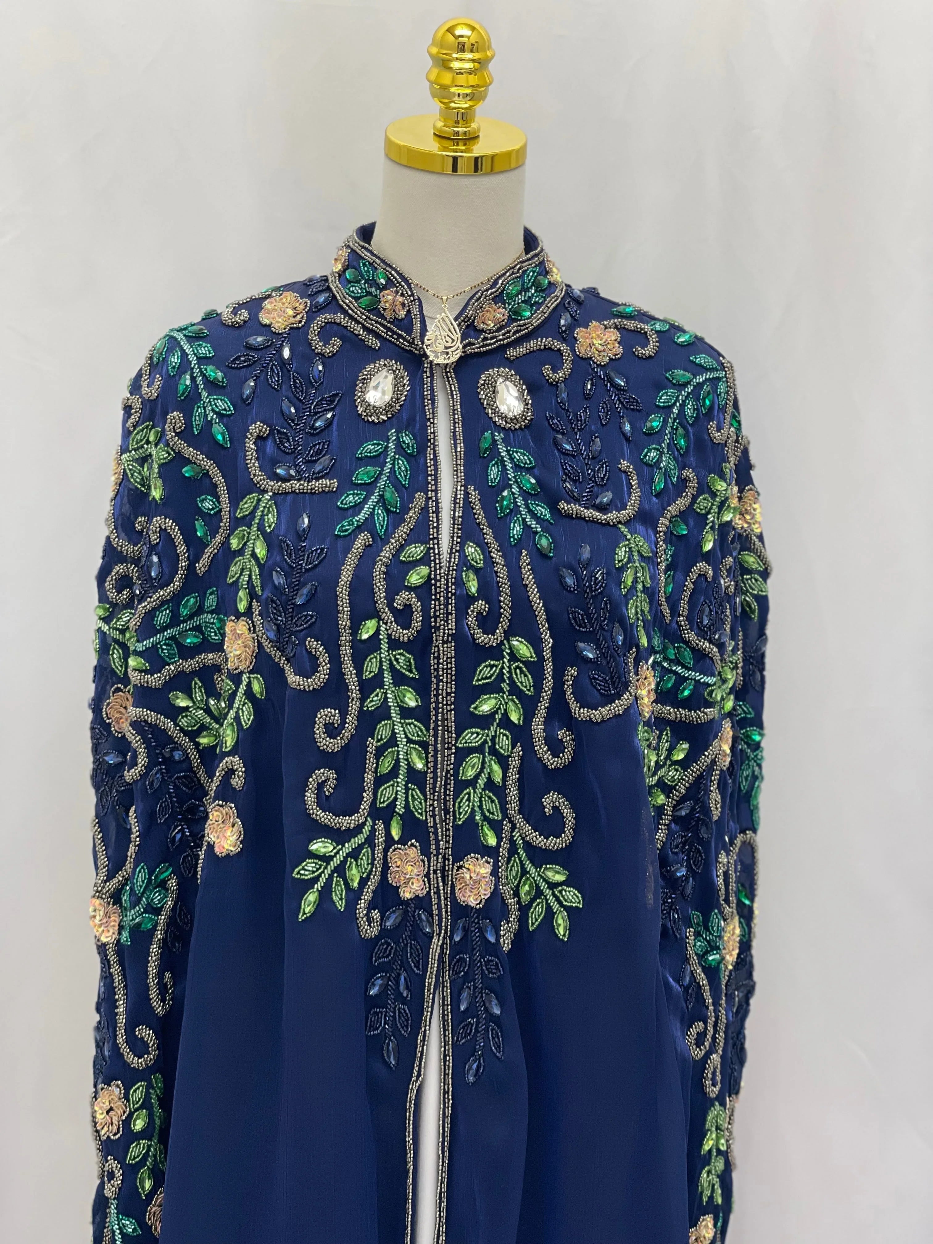 Royal Blue Bejeweled Cape cardigan by Palestinian Elegance decorated with intricate green and gold floral embroidery