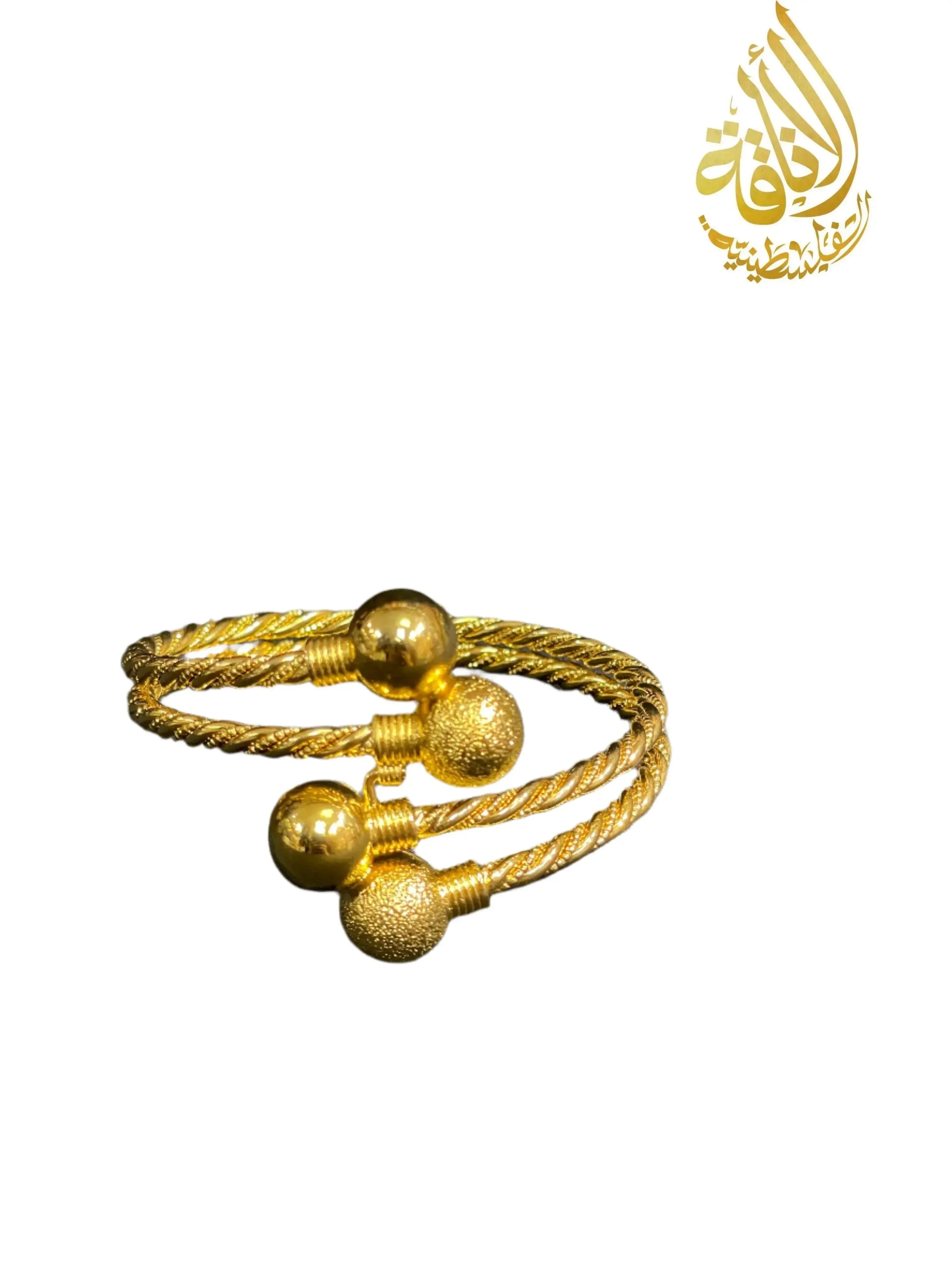 Palestinian Elegance Mabroma Gold Bracelet featuring twisted design with smooth and textured gold spheres