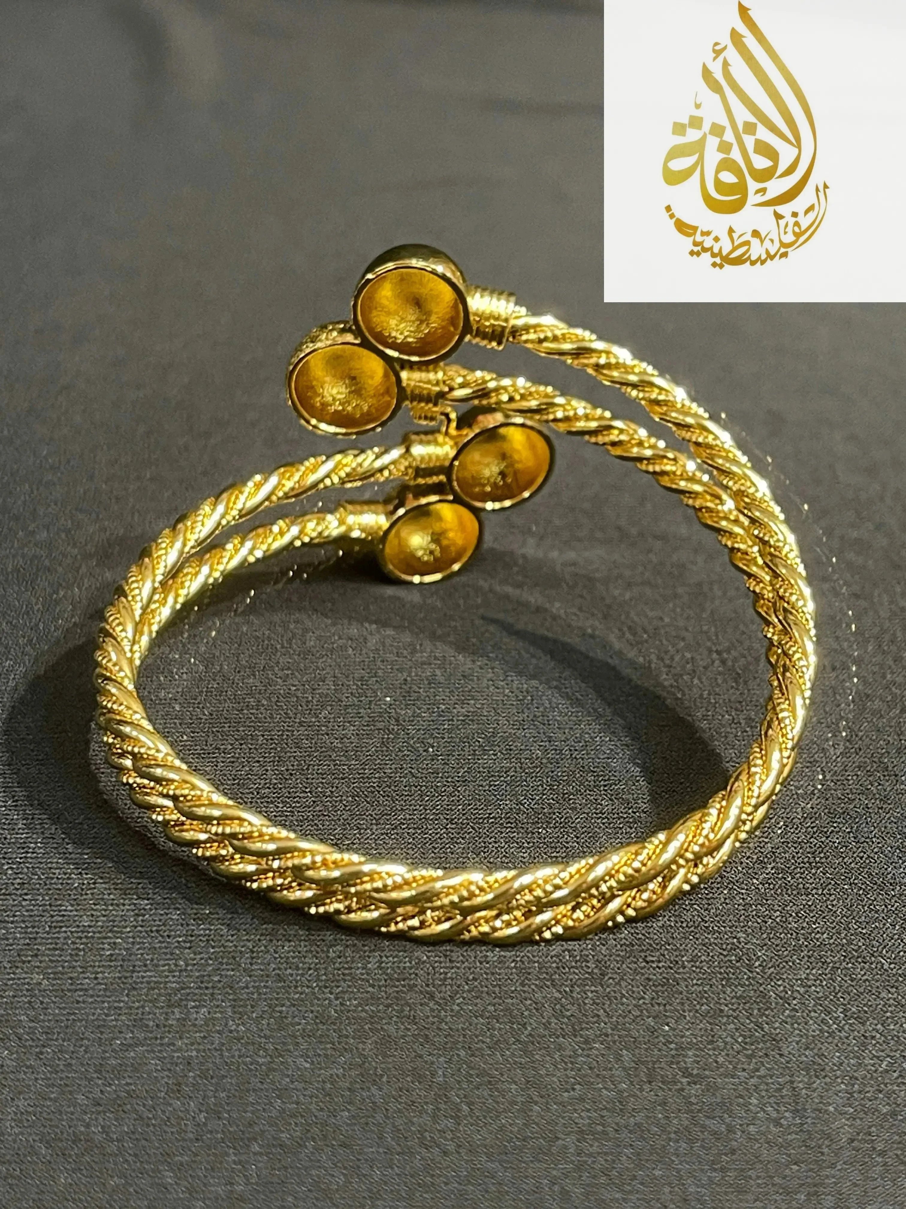Elegant Mabroma Gold Bracelet by Palestinian Elegance with twisted rope design and circular end details