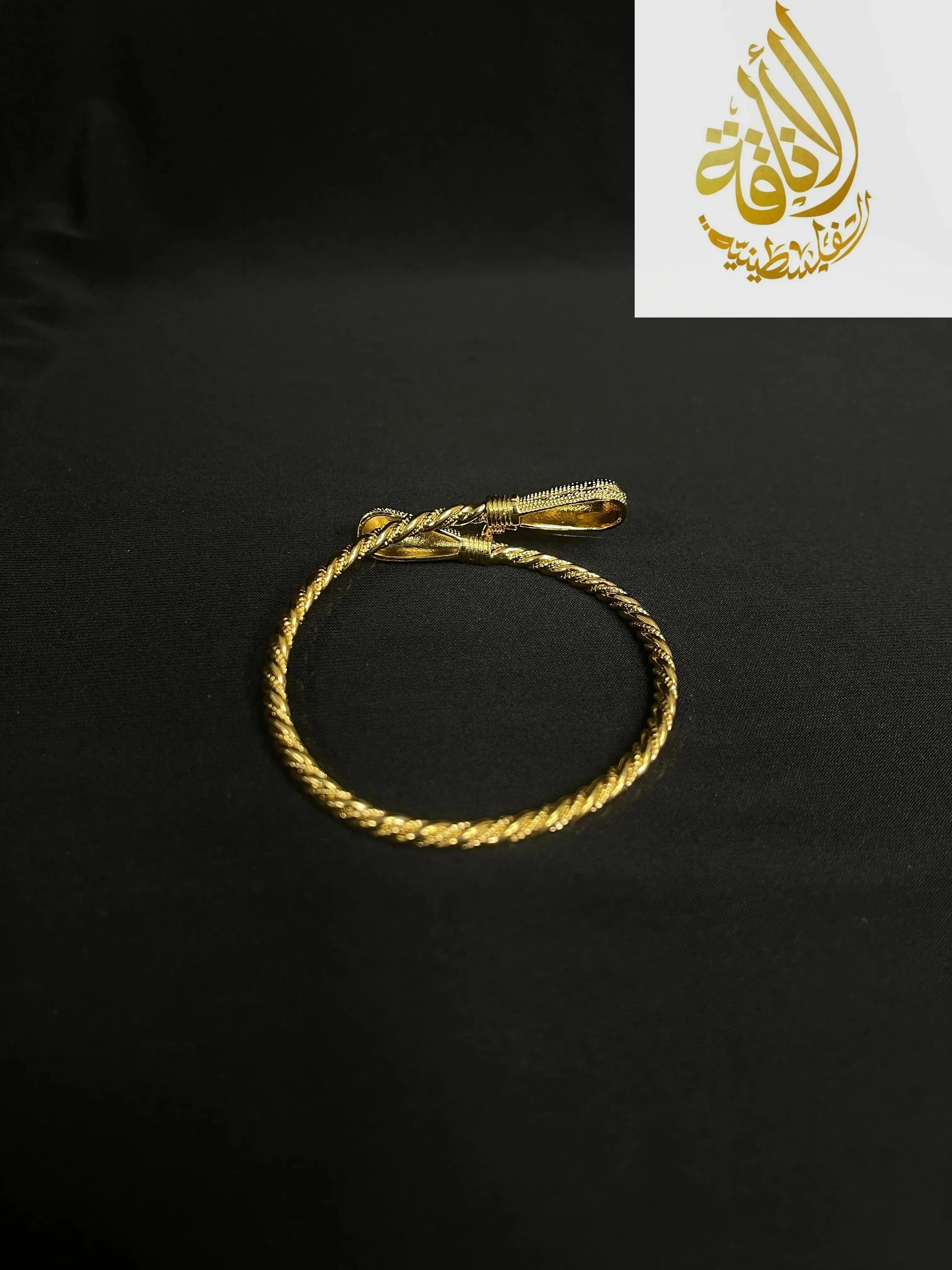 Palestinian Elegance imitated gold bracelet for women with twisted rope design on black background