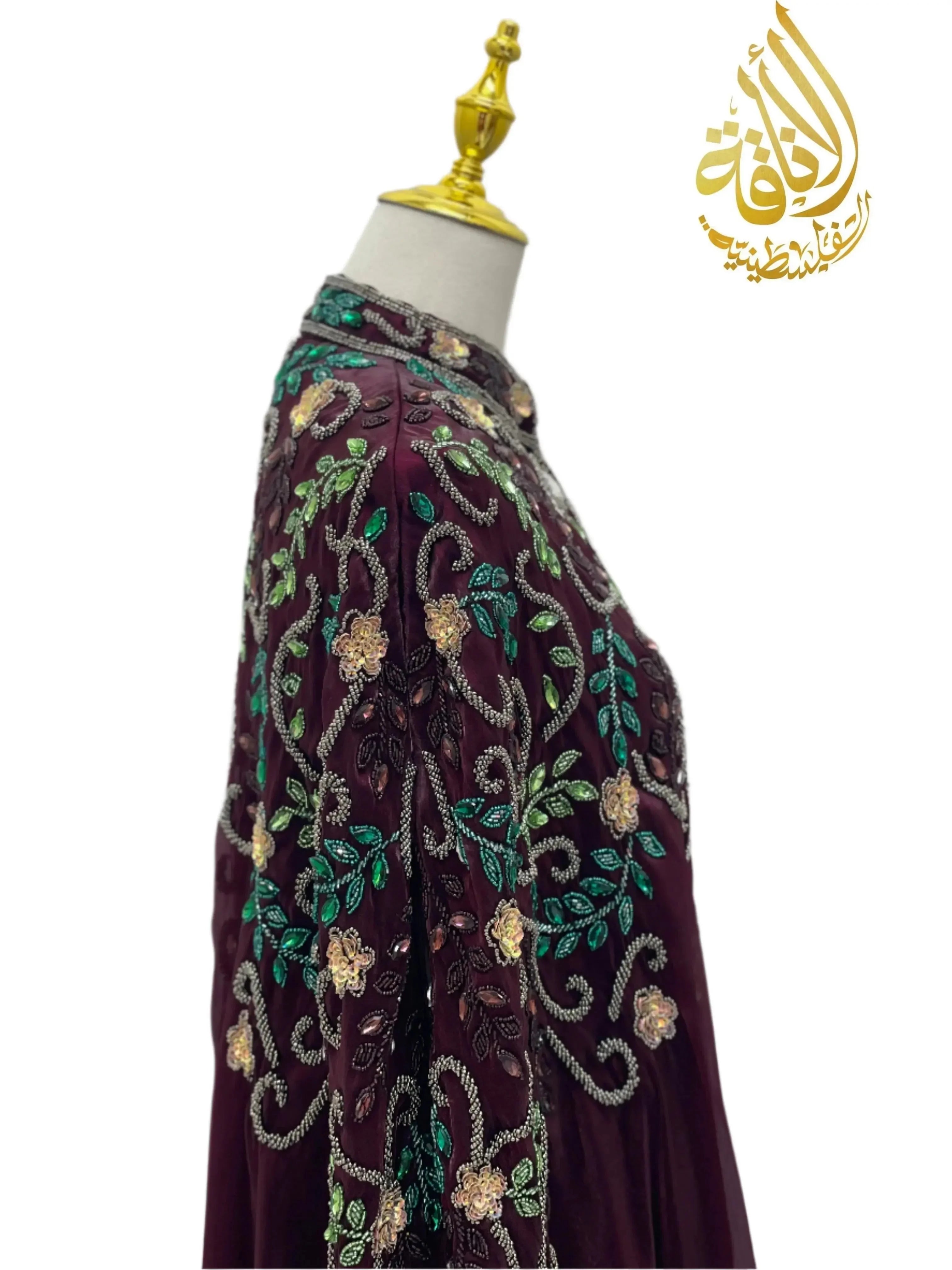 Palestinian Elegance luxury bejeweled cape abaya with intricate floral embroidery in green and gold on deep purple fabric