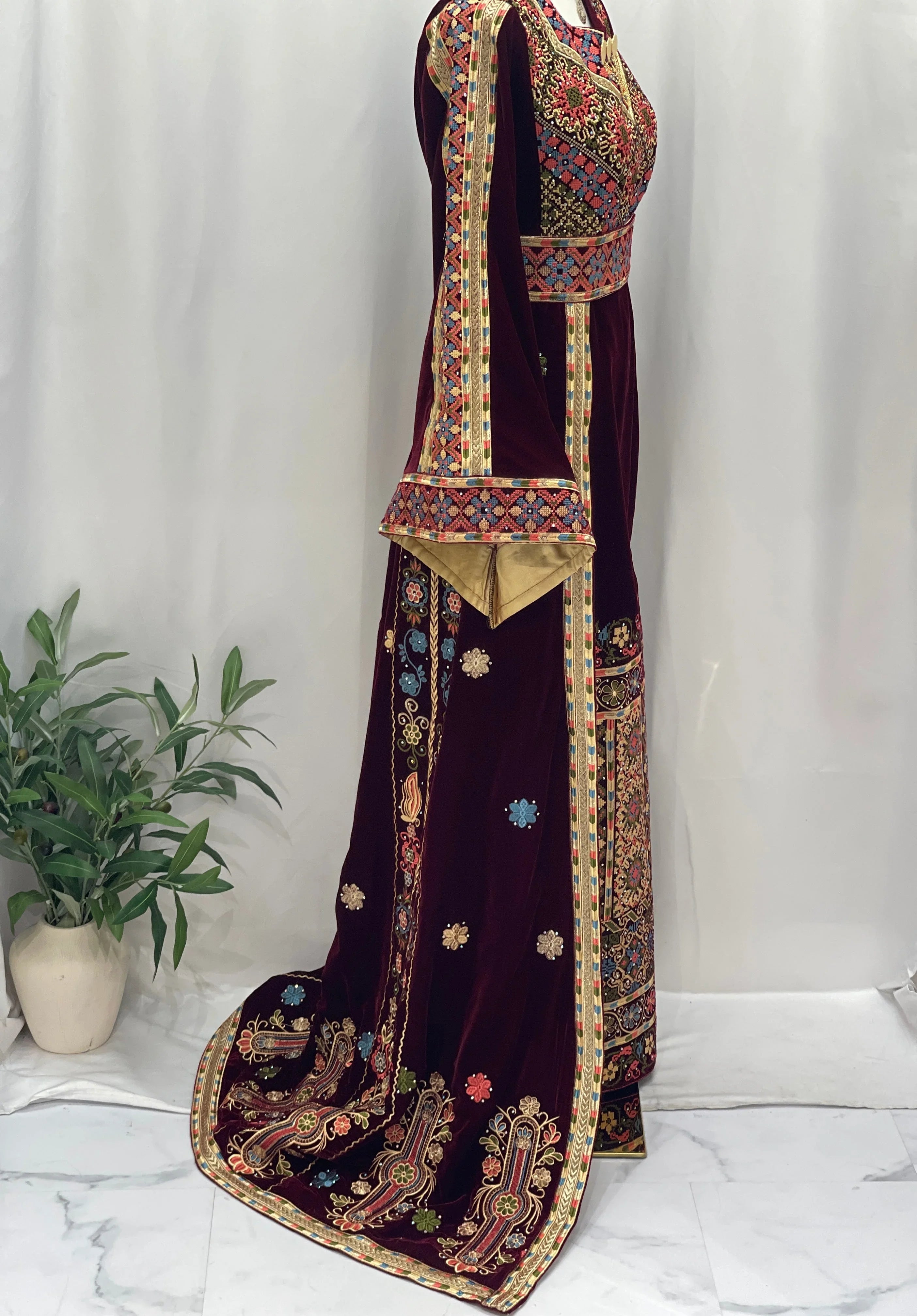 Maise Velevt Embroidered Thoub in burgundy velvet with intricate colorful designs and elegant sleeves