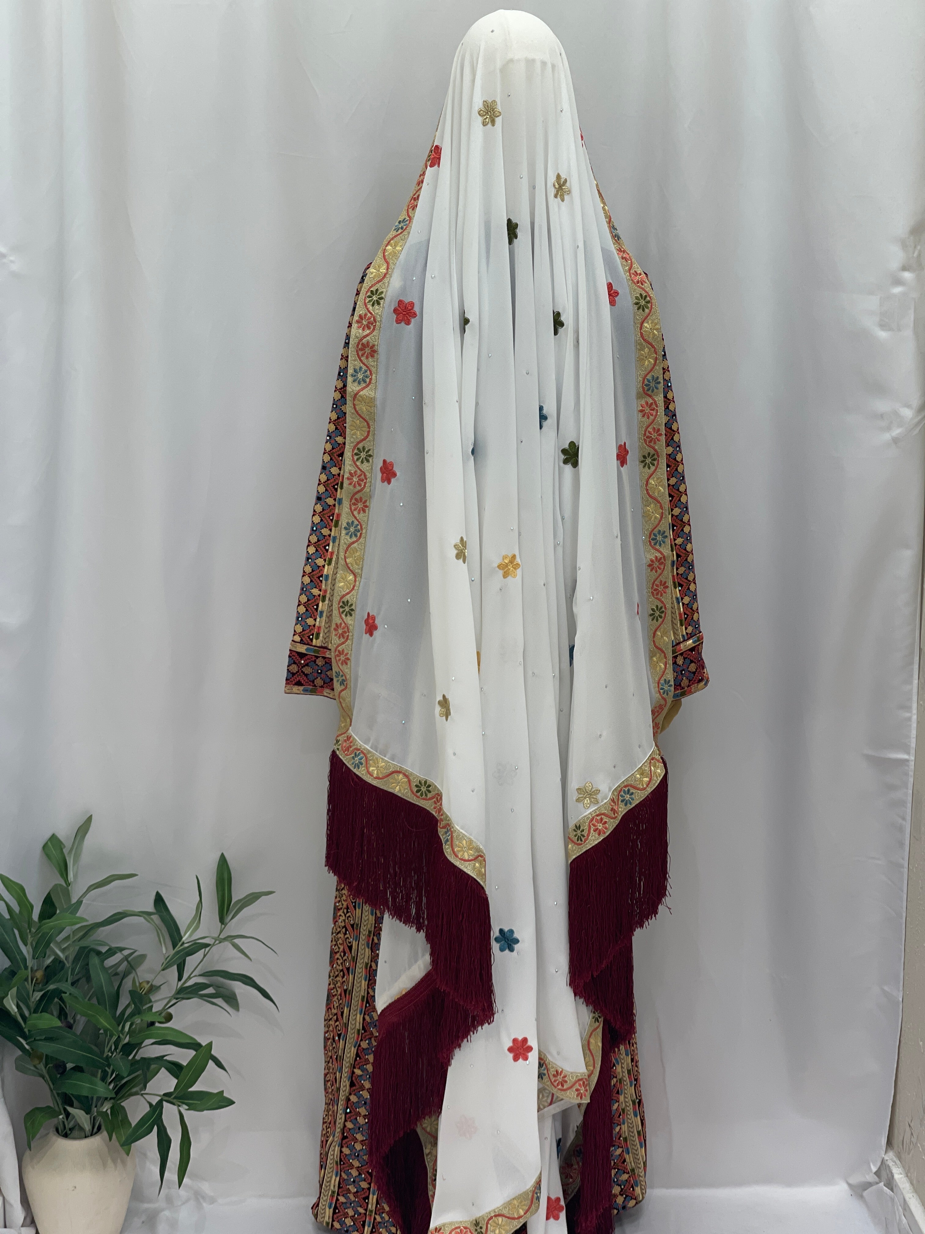 Maise Velevt Embroidered Thoub featuring vibrant floral designs and a decorative fringe, perfect for elegant occasions