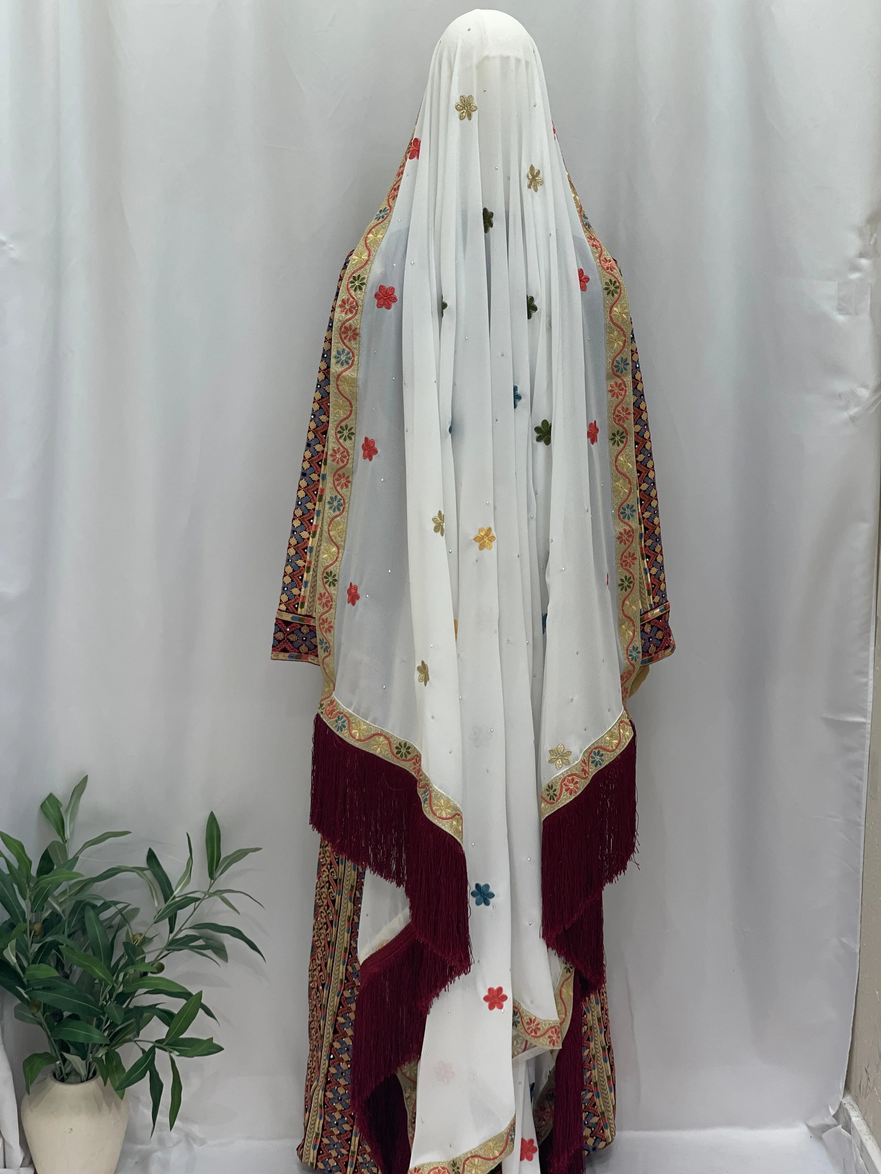 Maise Velevt Embroidered Thoub featuring vibrant floral designs and a decorative fringe, perfect for elegant occasions