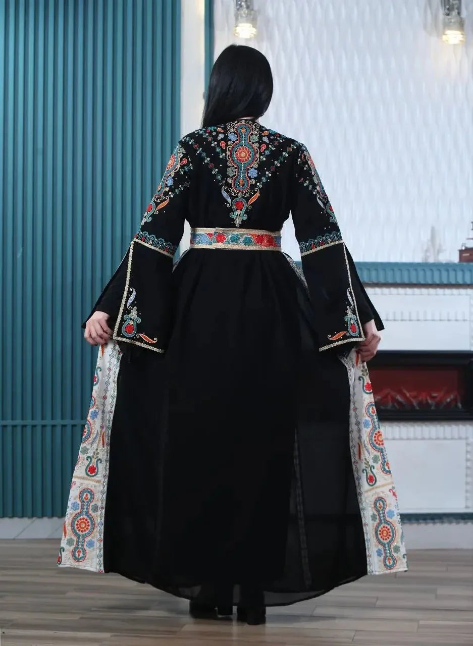 Back view of a woman wearing a black Malaki embroidered kaftan with colorful traditional Palestinian embroidery and wide sleeves