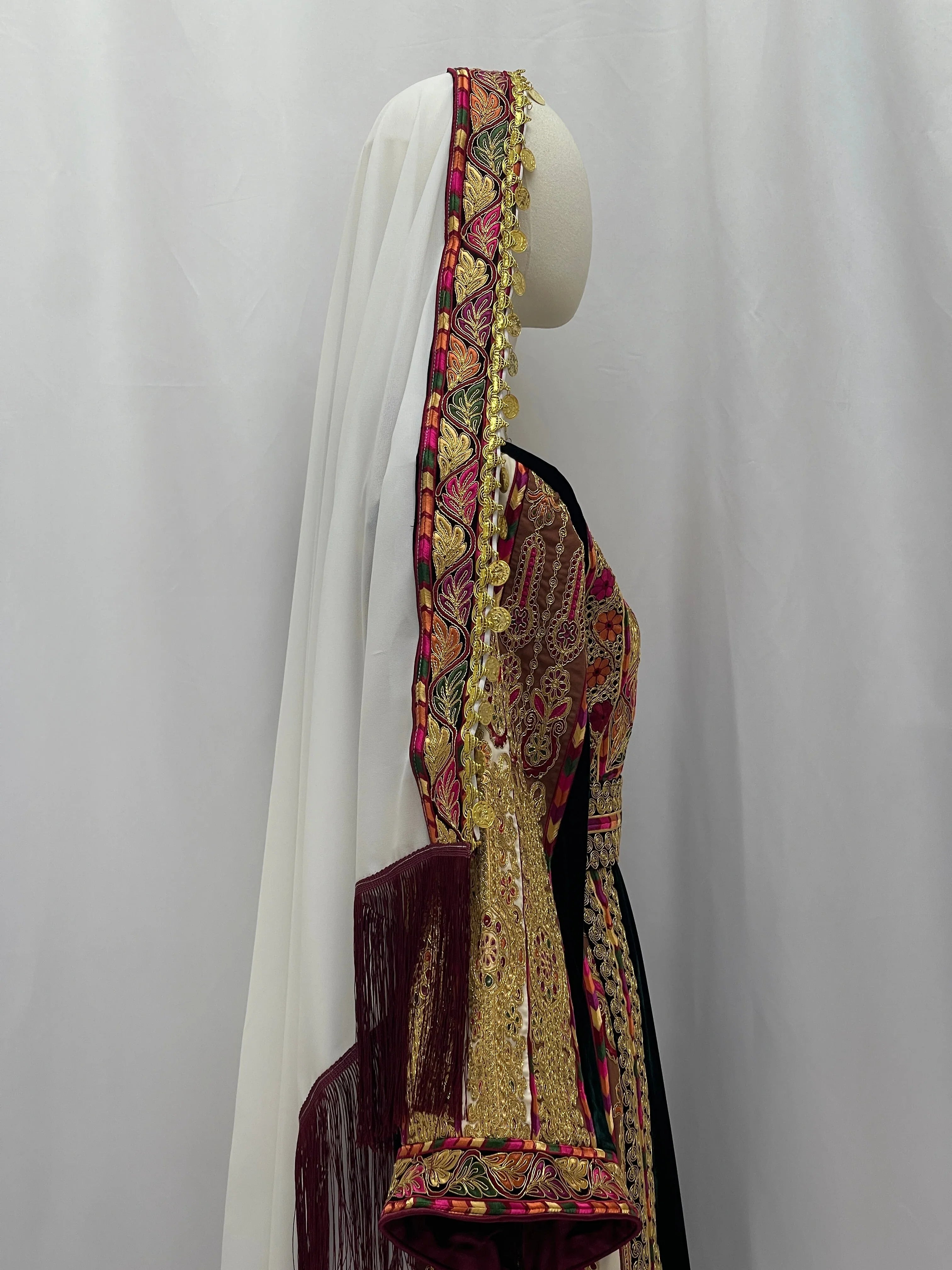 Malika Queen Emerald Thobe with intricate embroidery and elegant design showcased on a dress form