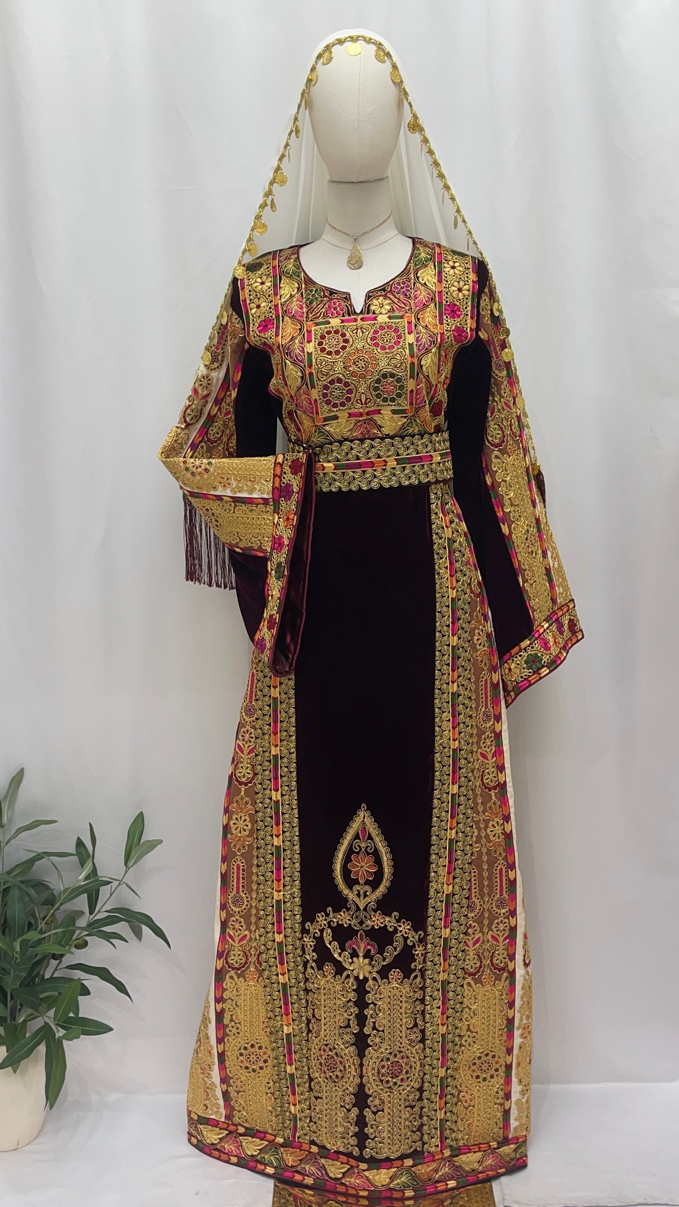 Palestinian Elegance Malikat al-Turath Thoub, an embroidered thobe with vibrant colors and intricate designs