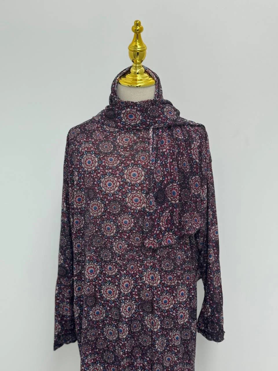 Palestinian Elegance Full Prayer Dress in dark floral geometric print with long sleeves and matching scarf on mannequin