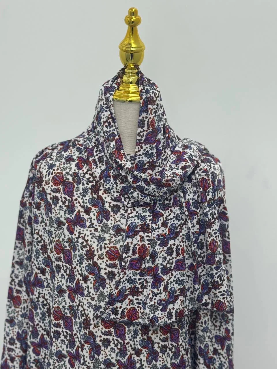 Palestinian Elegance Full Prayer Dress on mannequin white base with purple and red paisley floral print