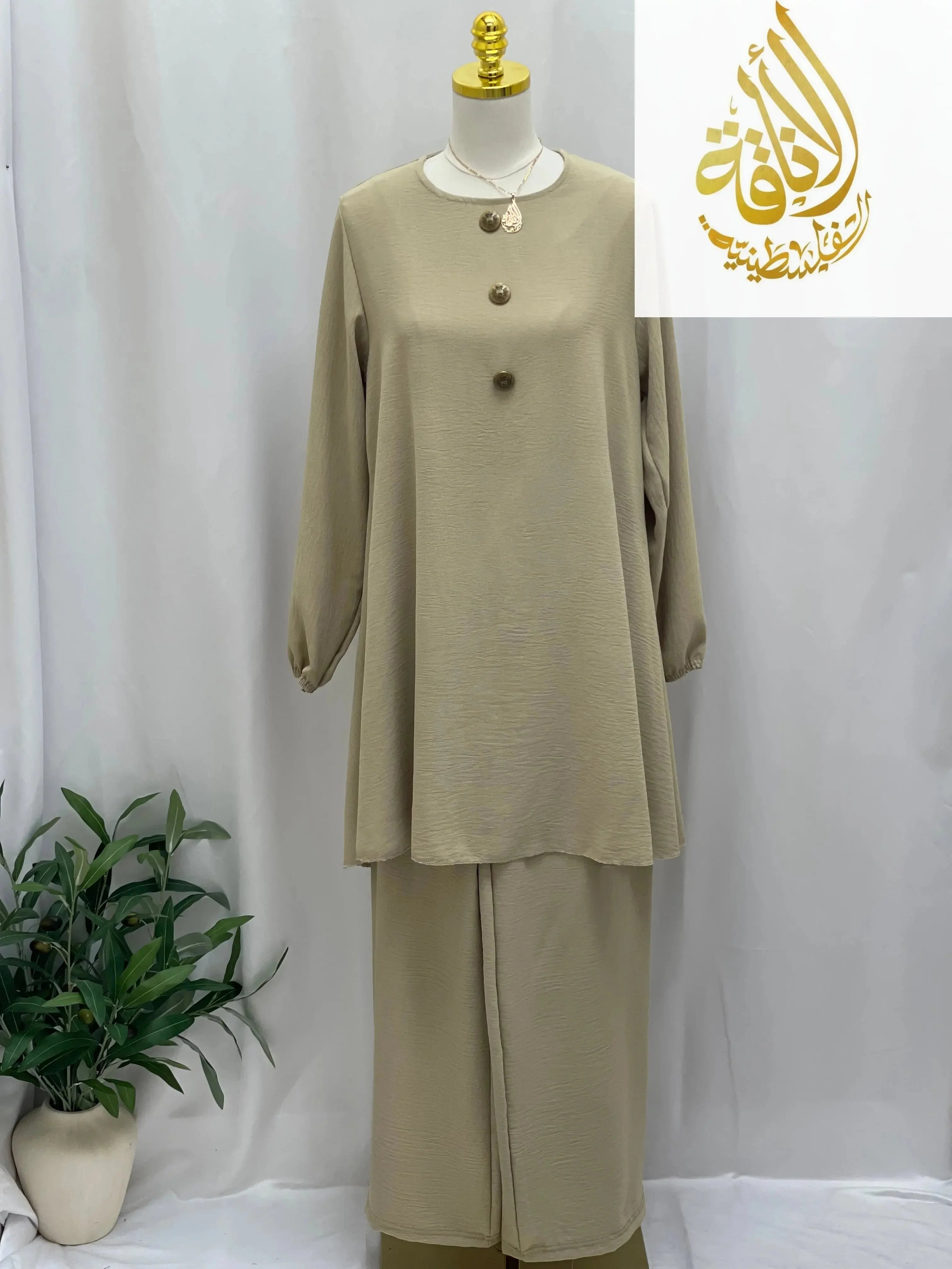 Beige modest long tunic and pant set with long sleeves and button details displayed on a mannequin