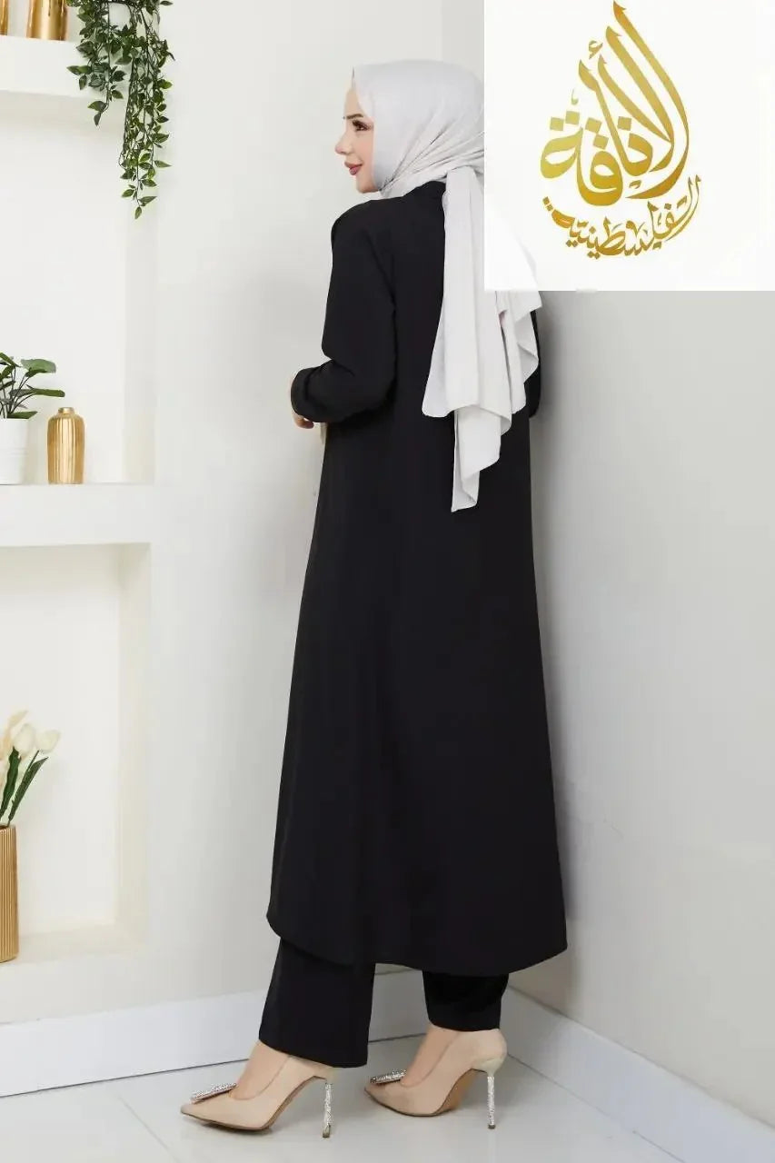 Palestinian Elegance modesty long set in black featuring a long modest outfit set with matching pants and a white hijab