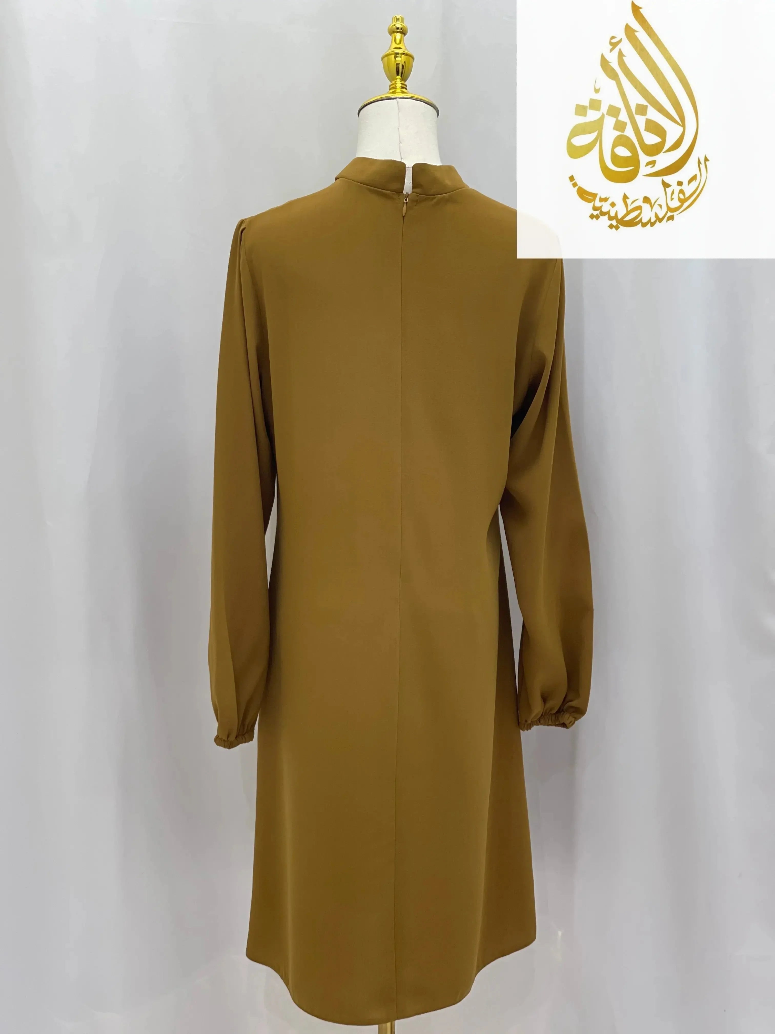 Brown modest embroidered tunic dress with long sleeves and high neckline on mannequin