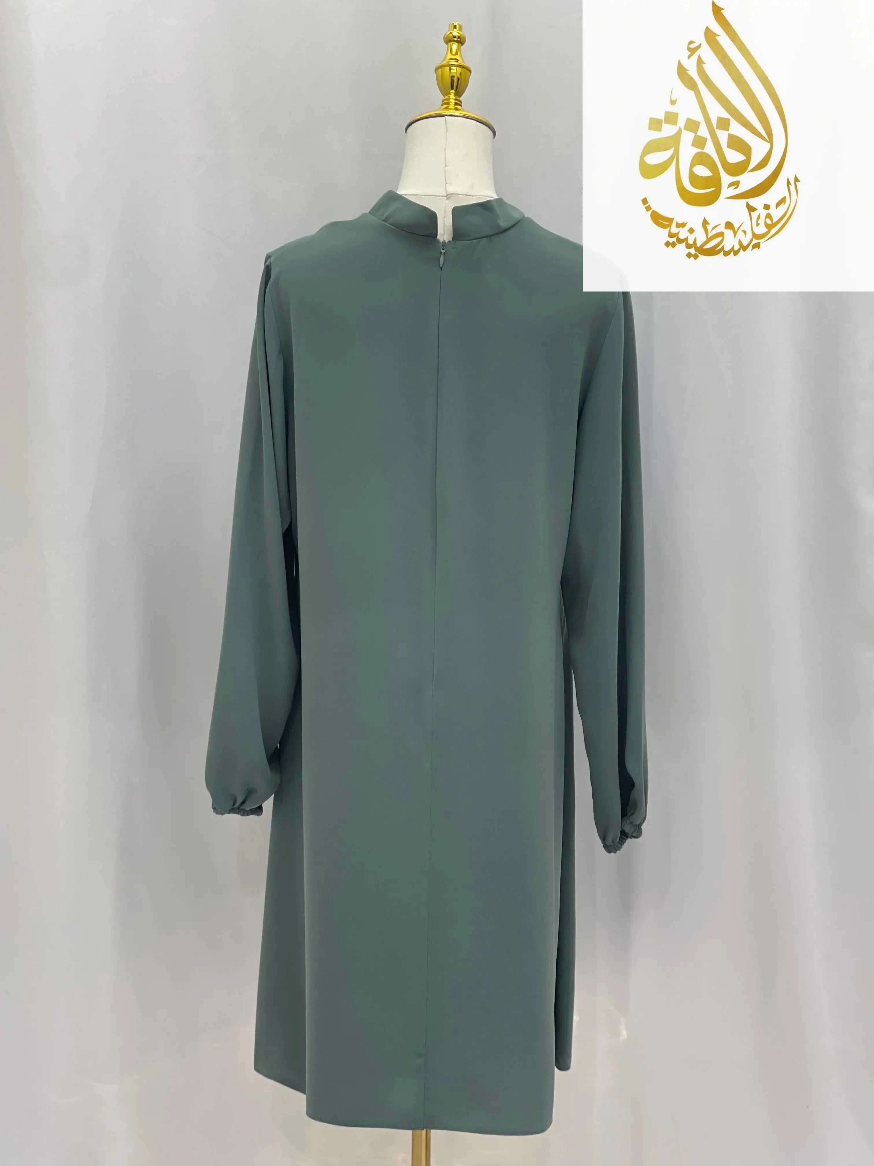 Palestinian Elegance modest embroidered tunic dress in muted green with long sleeves and high collar