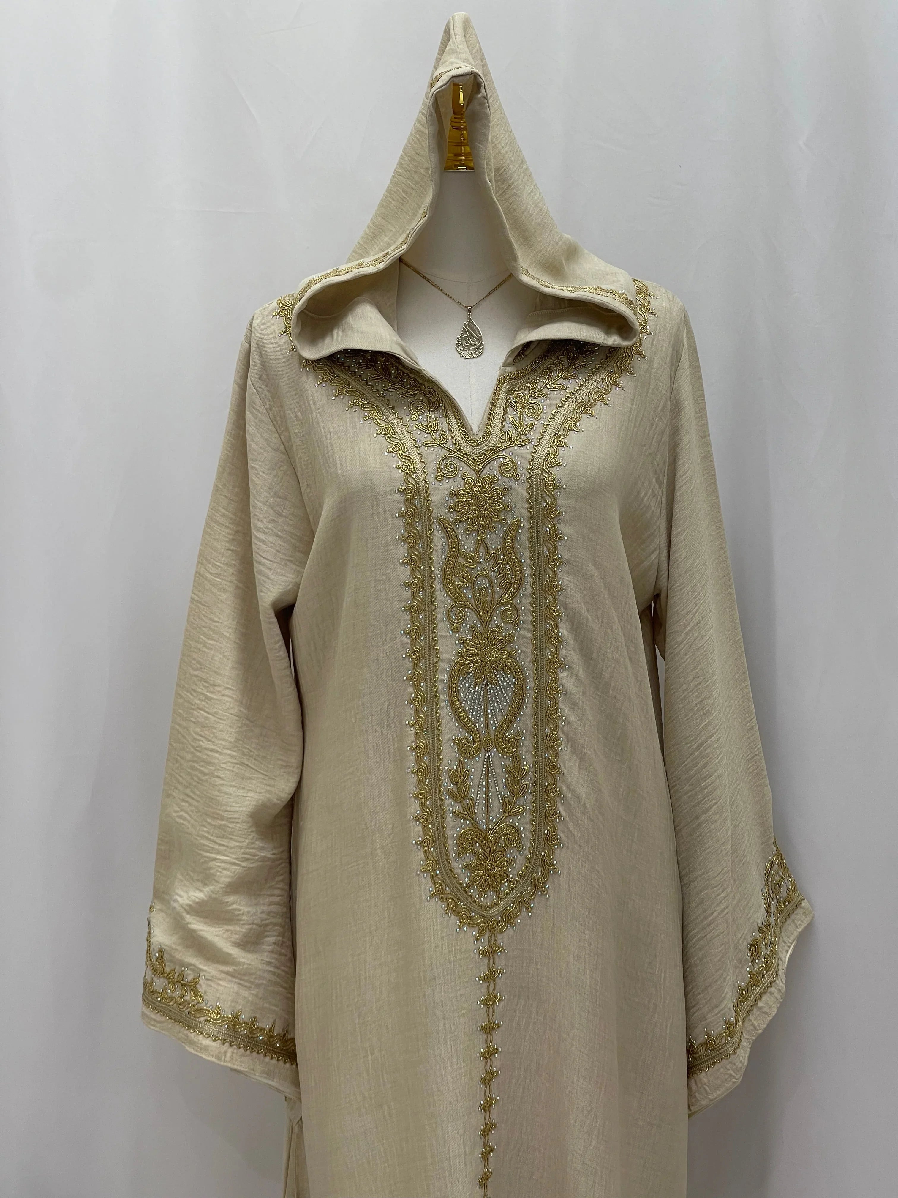 Palestinian Elegance cream hooded abaya with intricate gold embroidered panel and pendant necklace Moroccan Embroidered Djellaba