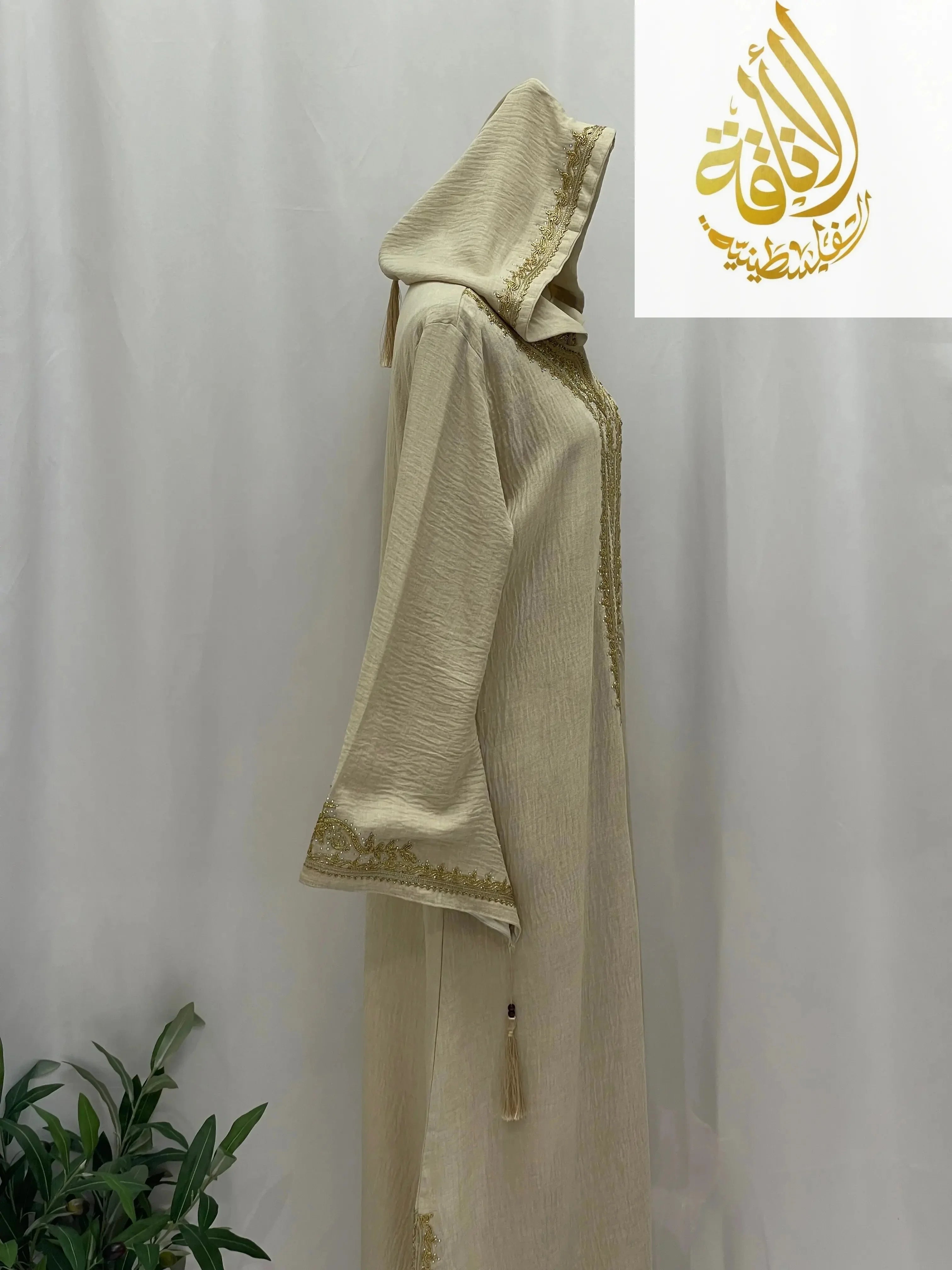 Palestinian Elegance beige hooded abaya with gold trim and tassel Moroccan Embroidered Djellaba in textured fabric