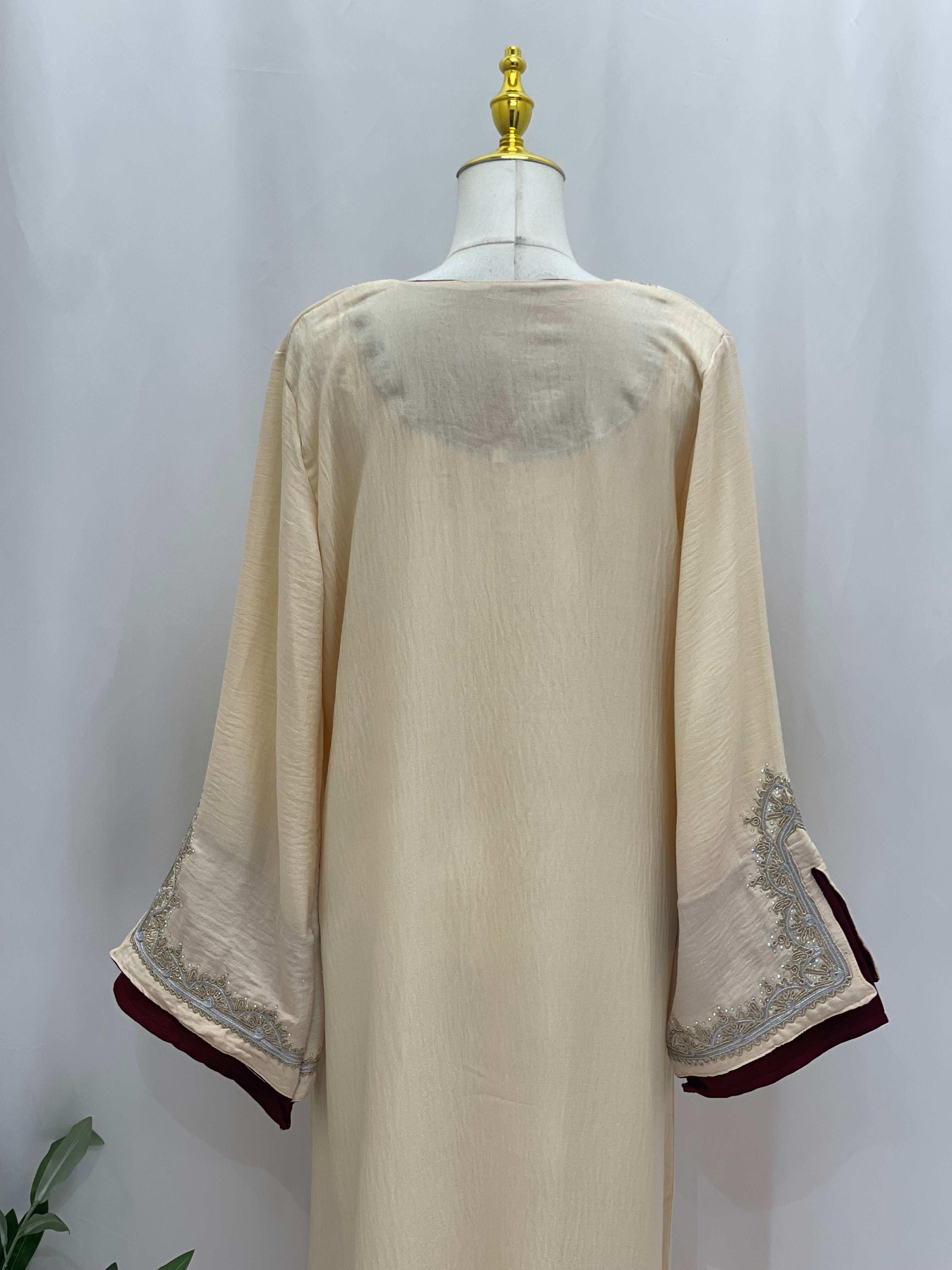 Back view of Palestinian Elegance Moroccan Rana Jalabia abaya in beige with intricate sleeve embroidery
