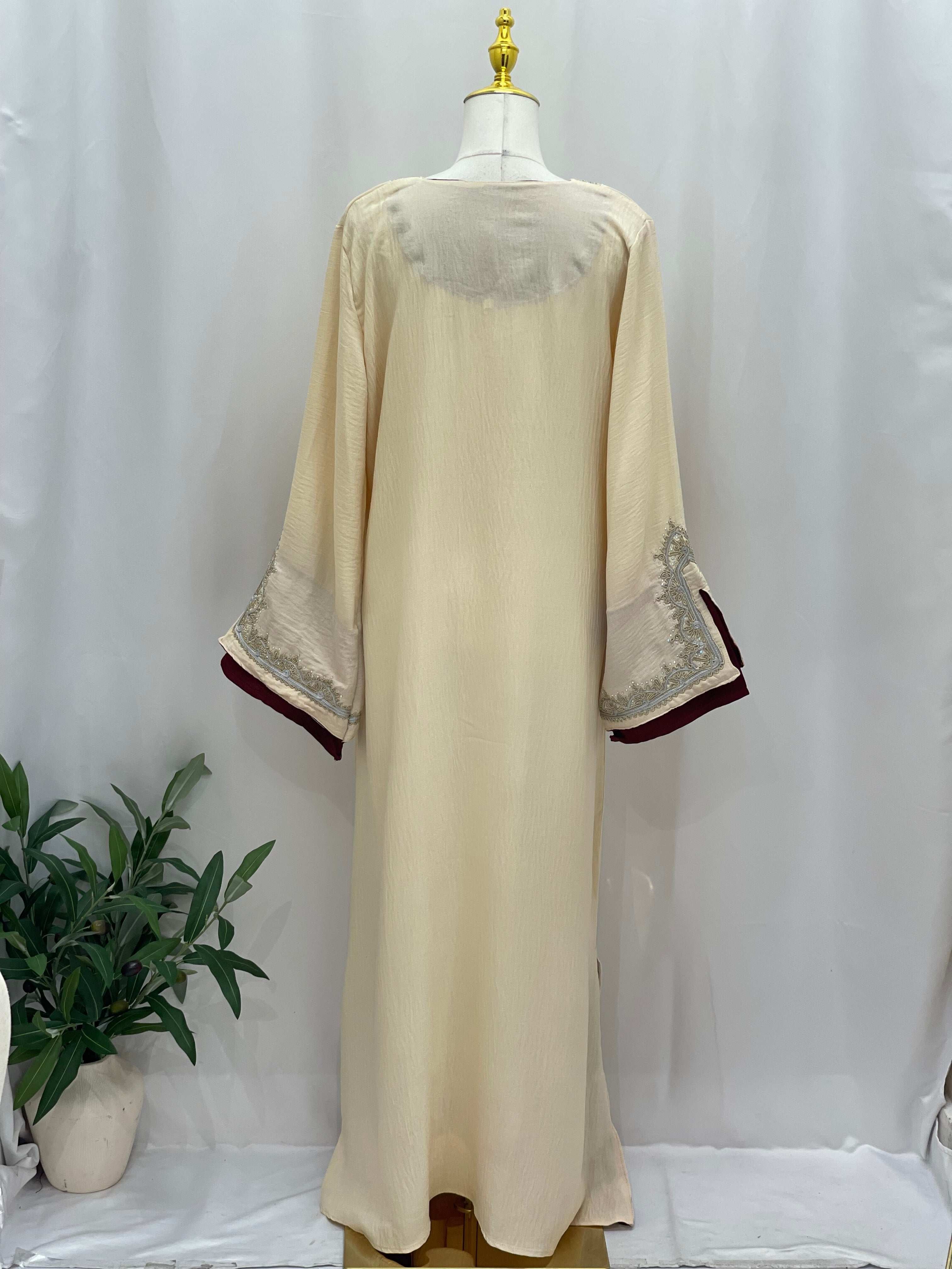 Palestinian Elegance Moroccan Rana Jalabia beige abaya with intricate sleeve embroidery shown from the back