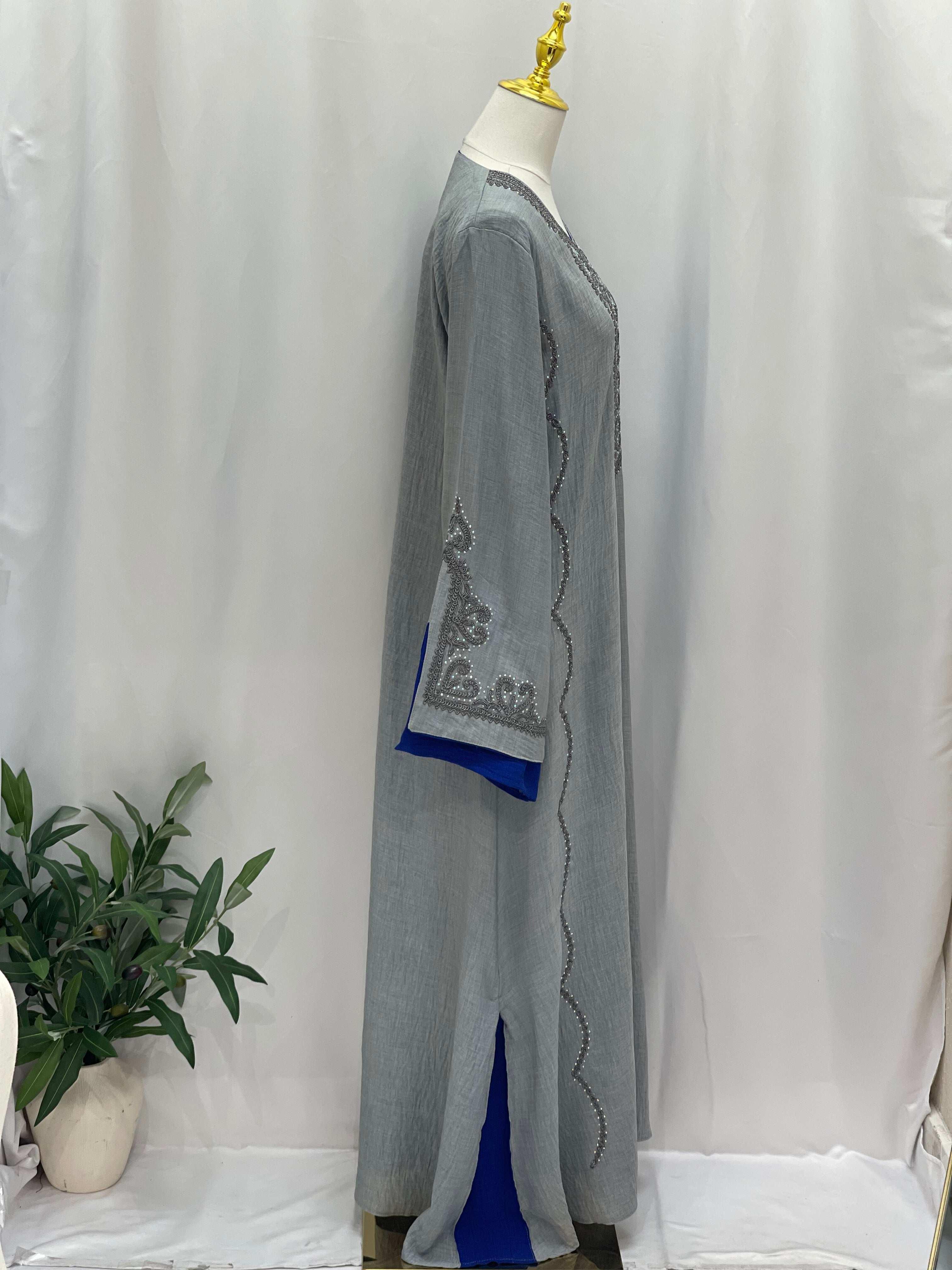 Palestinian Elegance Moroccan Rana Jalabia gray abaya with blue accents and intricate sleeve embroidery