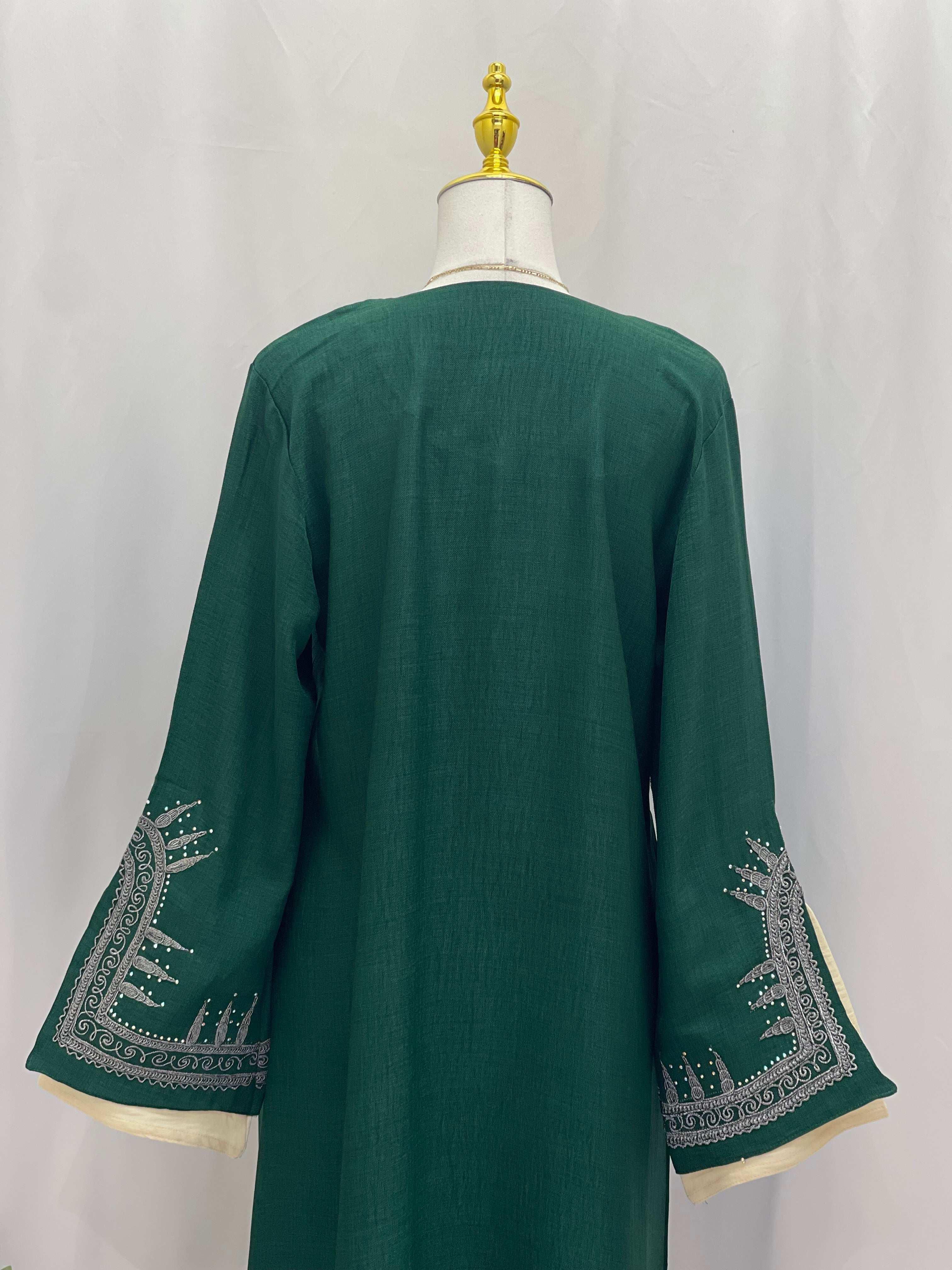 Back view of a green Moroccan Salma Jalabia abaya with silver embroidery on wide sleeves from Palestinian Elegance