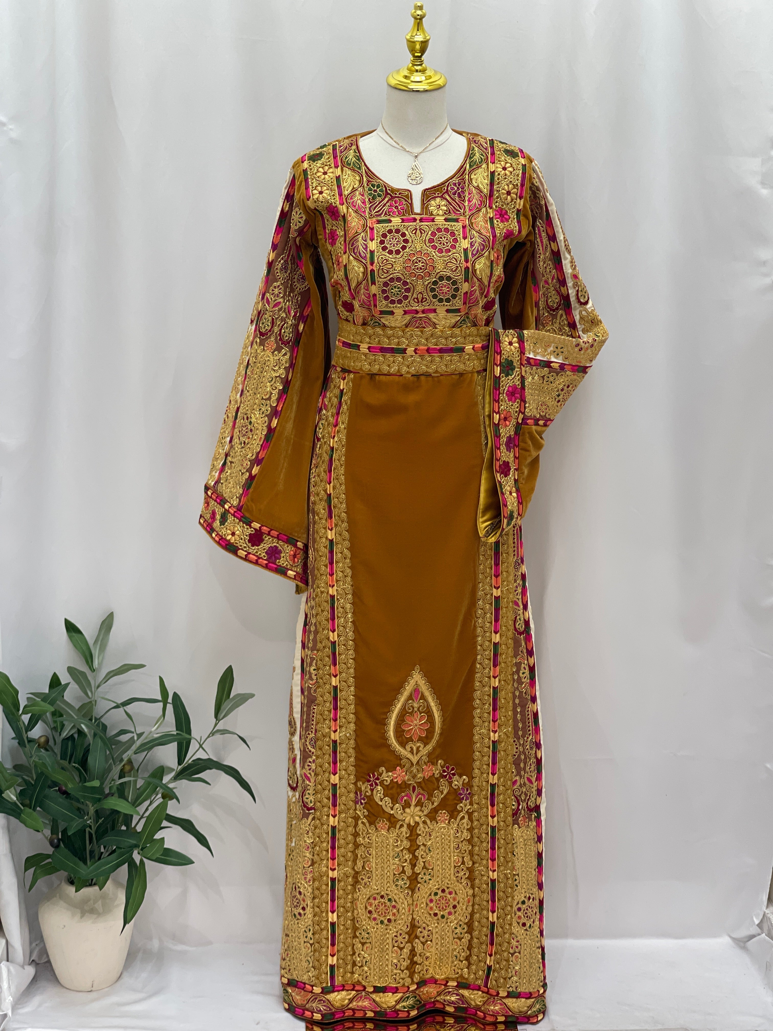 Traditional Malaka Embroidered Thoub by Palestinian Elegance in rich gold and pink detailed fabric