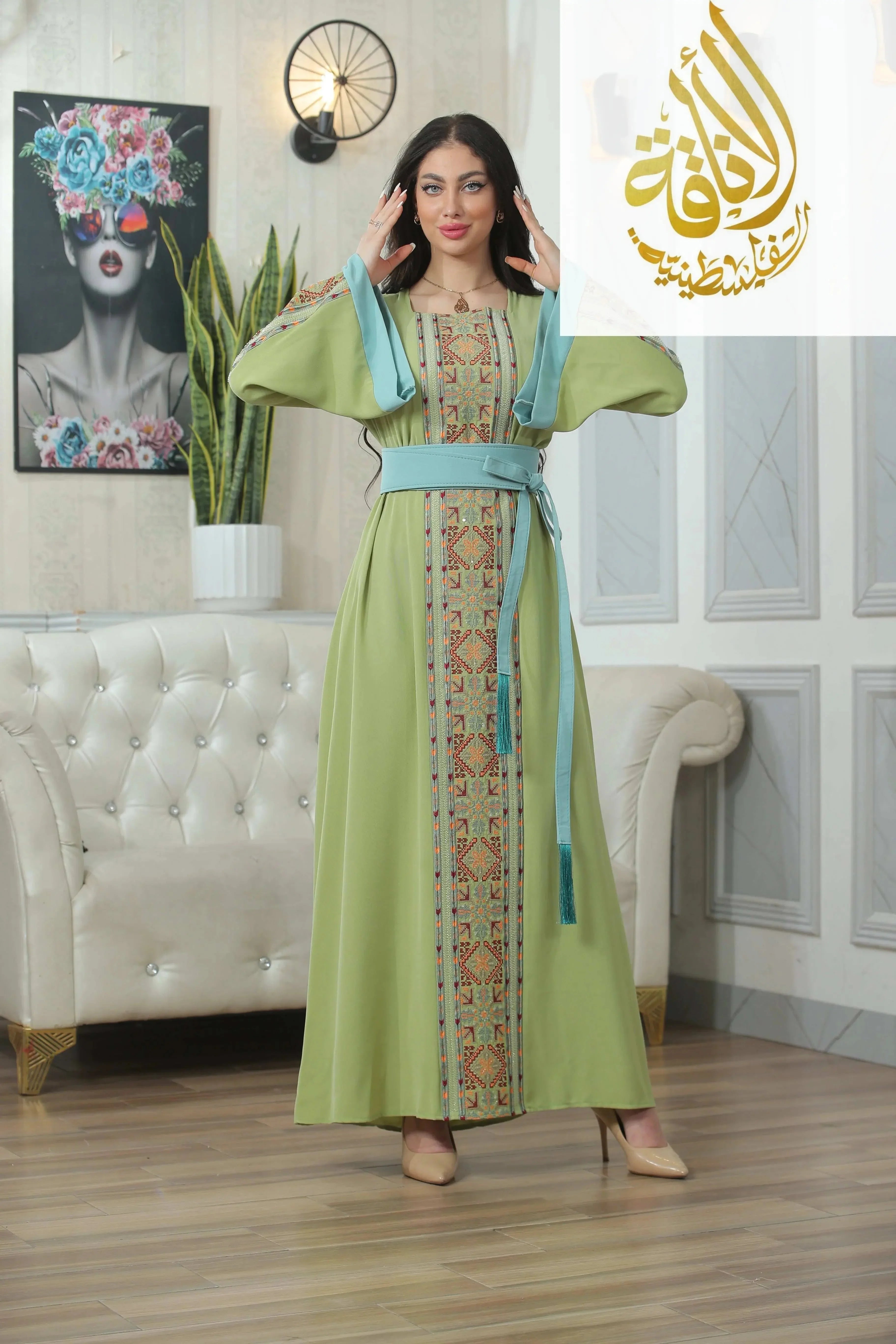 Palestinian Elegance Nadera Embroidered Thoub in green with intricate traditional embroidery and blue belt