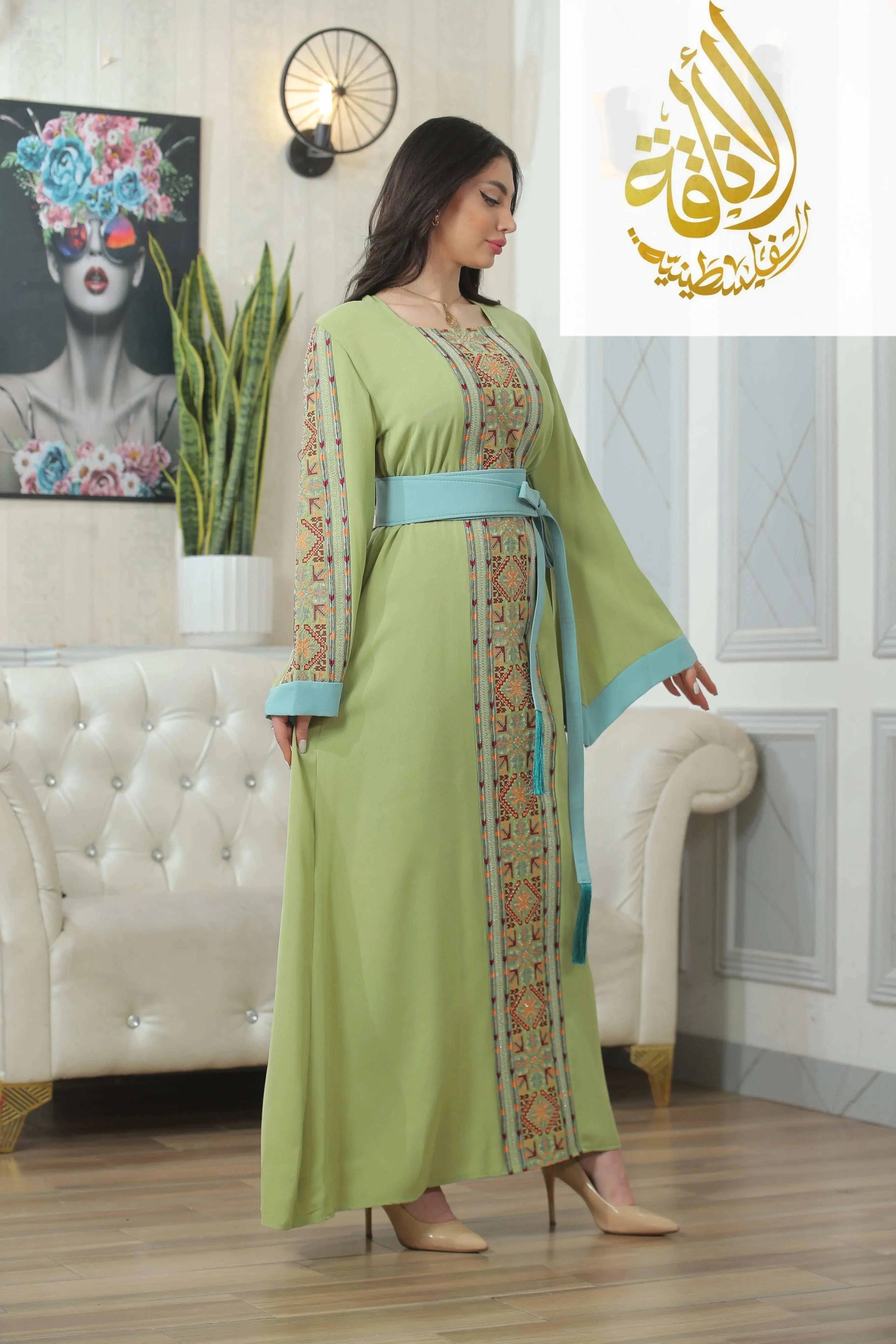 Nadera Embroidered Thoub by Palestinian Elegance in light green with colorful traditional embroidery and blue belt
