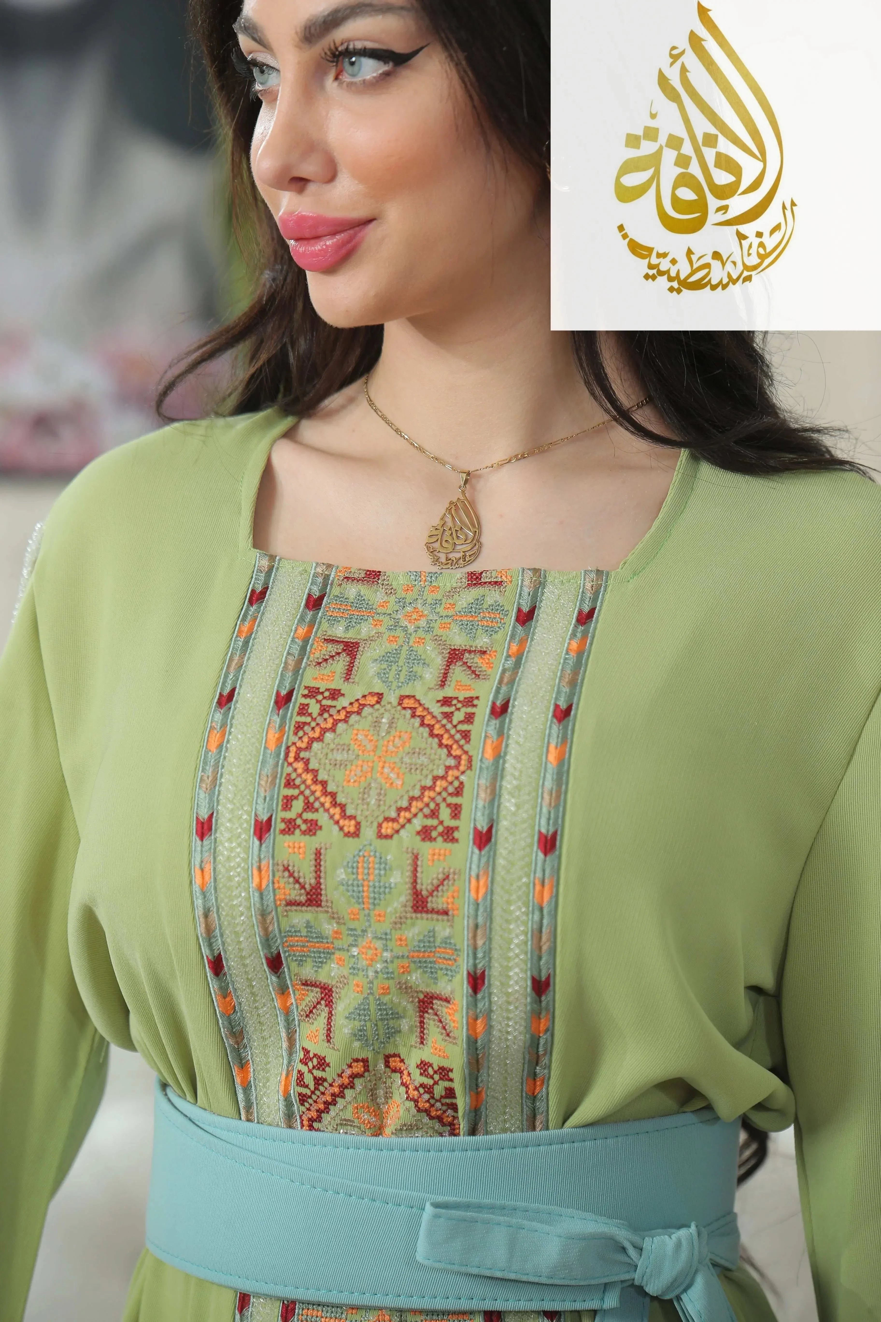 Palestinian Elegance Nadera Embroidered Thoub with intricate embroidery and a light green fabric dress