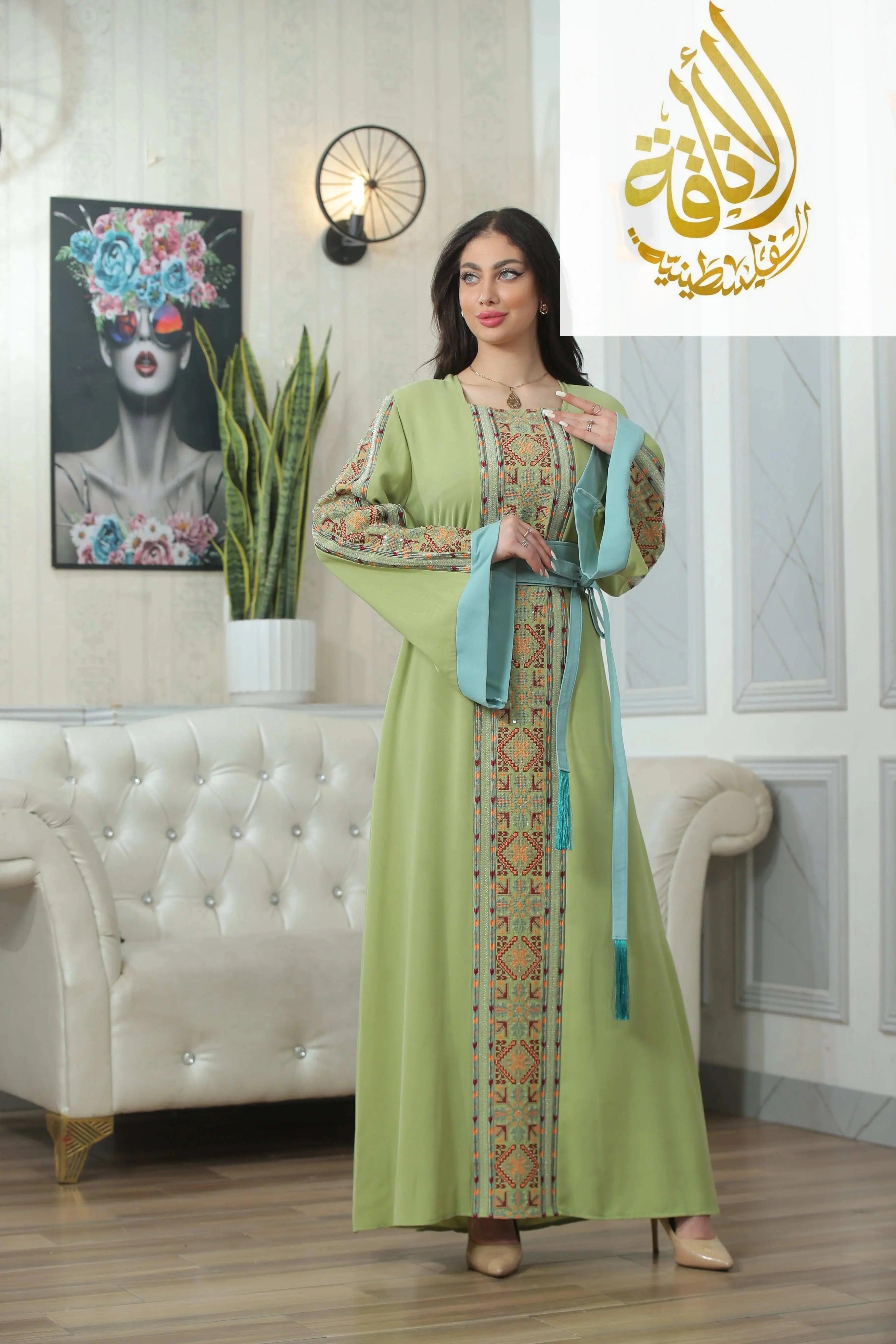 Palestinian Elegance Nadera Embroidered Thoub in light green with intricate traditional patterns and blue sash
