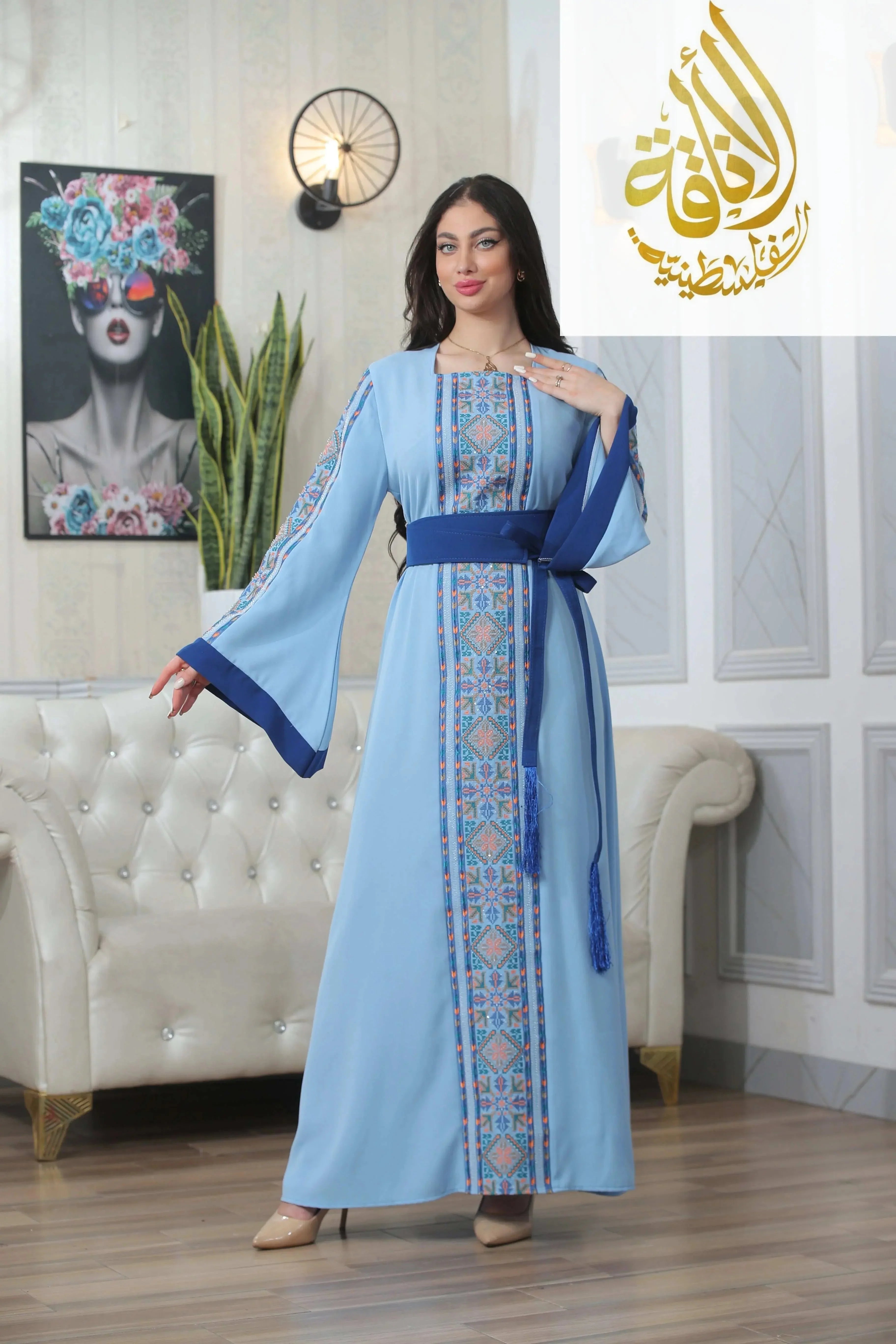 Palestinian Elegance Nadera Embroidered Thoub in light blue with intricate front embroidery and wide sleeves