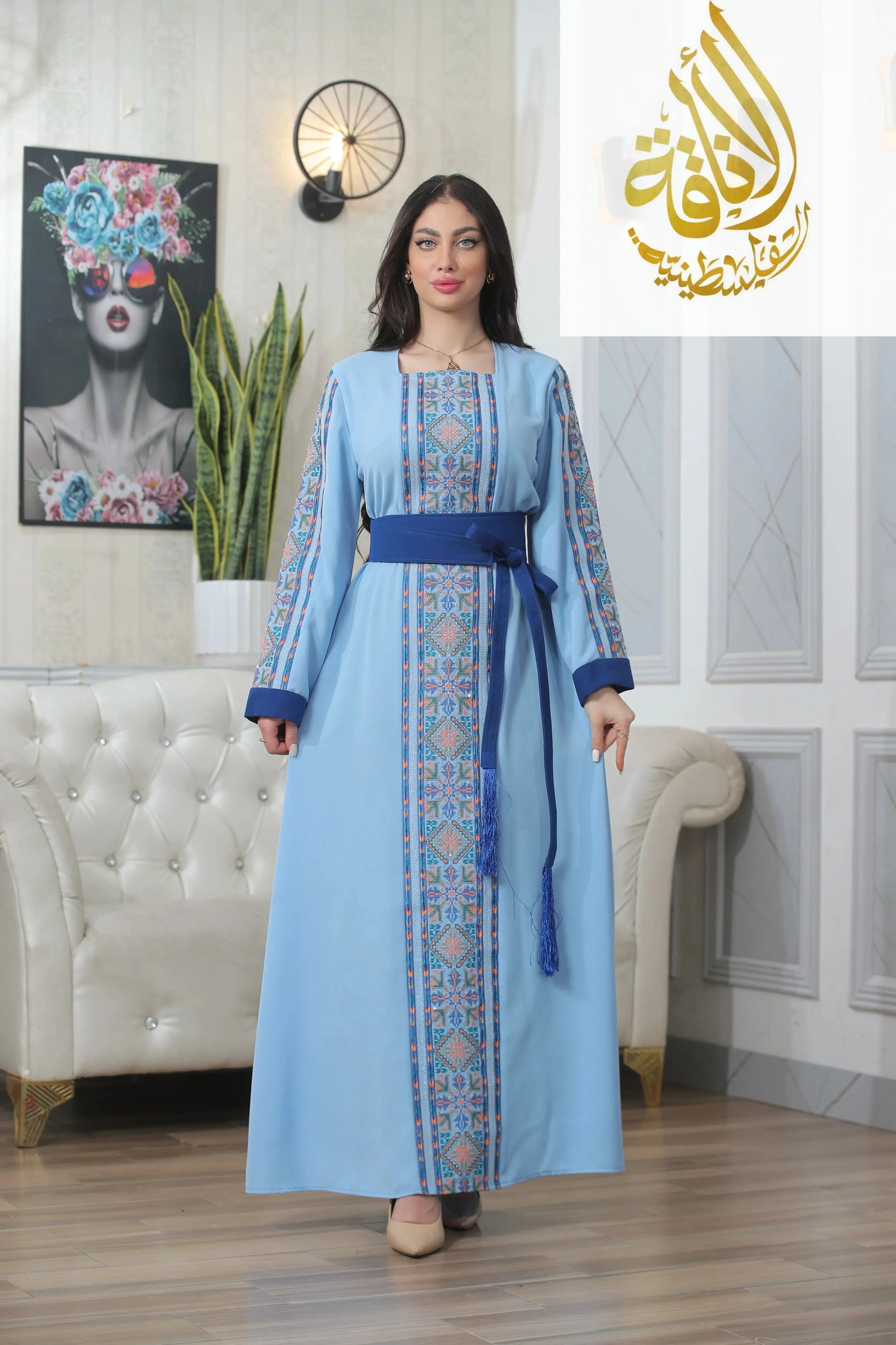Palestinian Elegance Nadera Embroidered Thoub in blue with intricate front and sleeve embroidery and matching belt