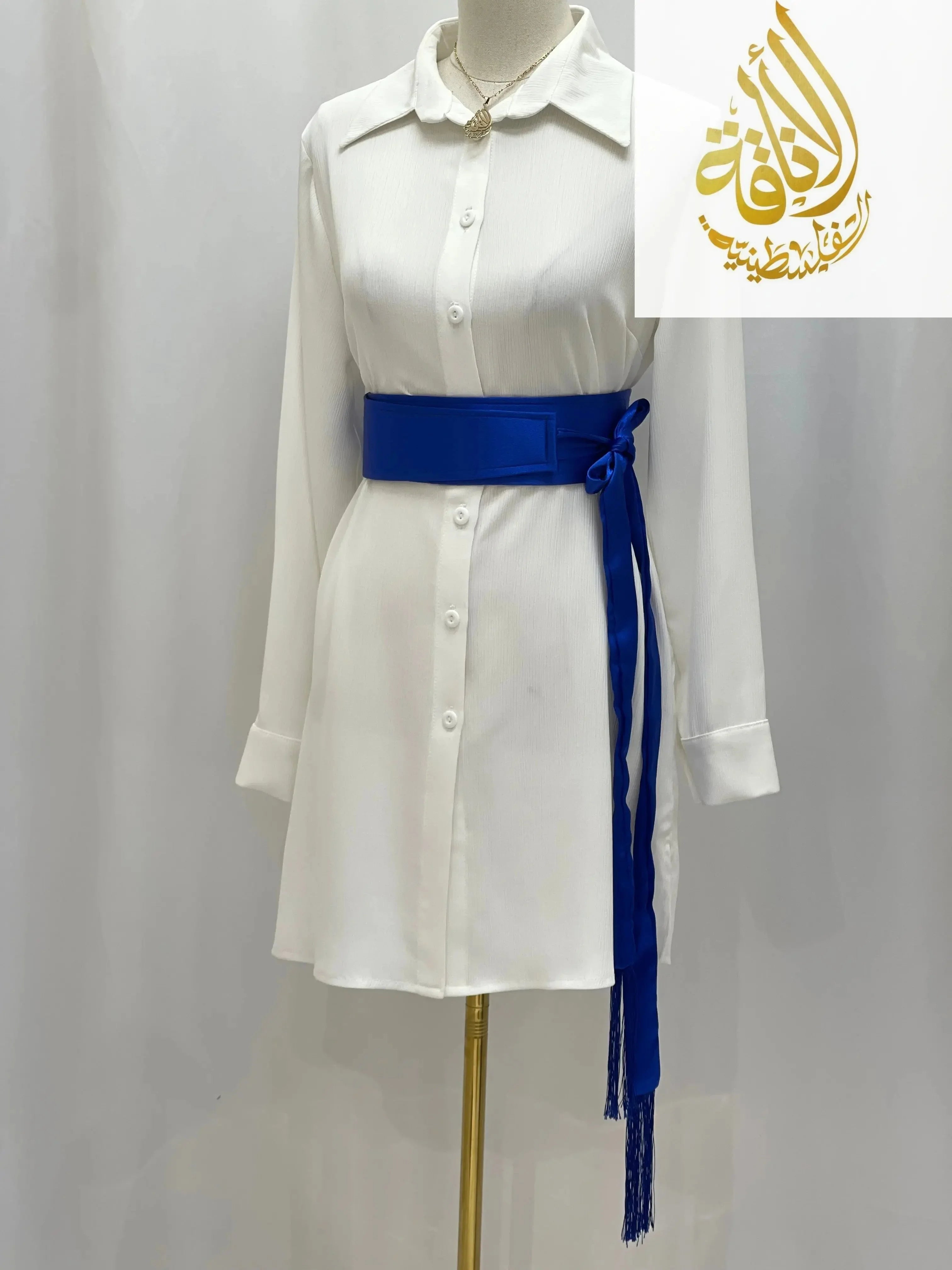 Palestinian Elegance blue satin belt for dresses styled on white button-down dress with long sleeves