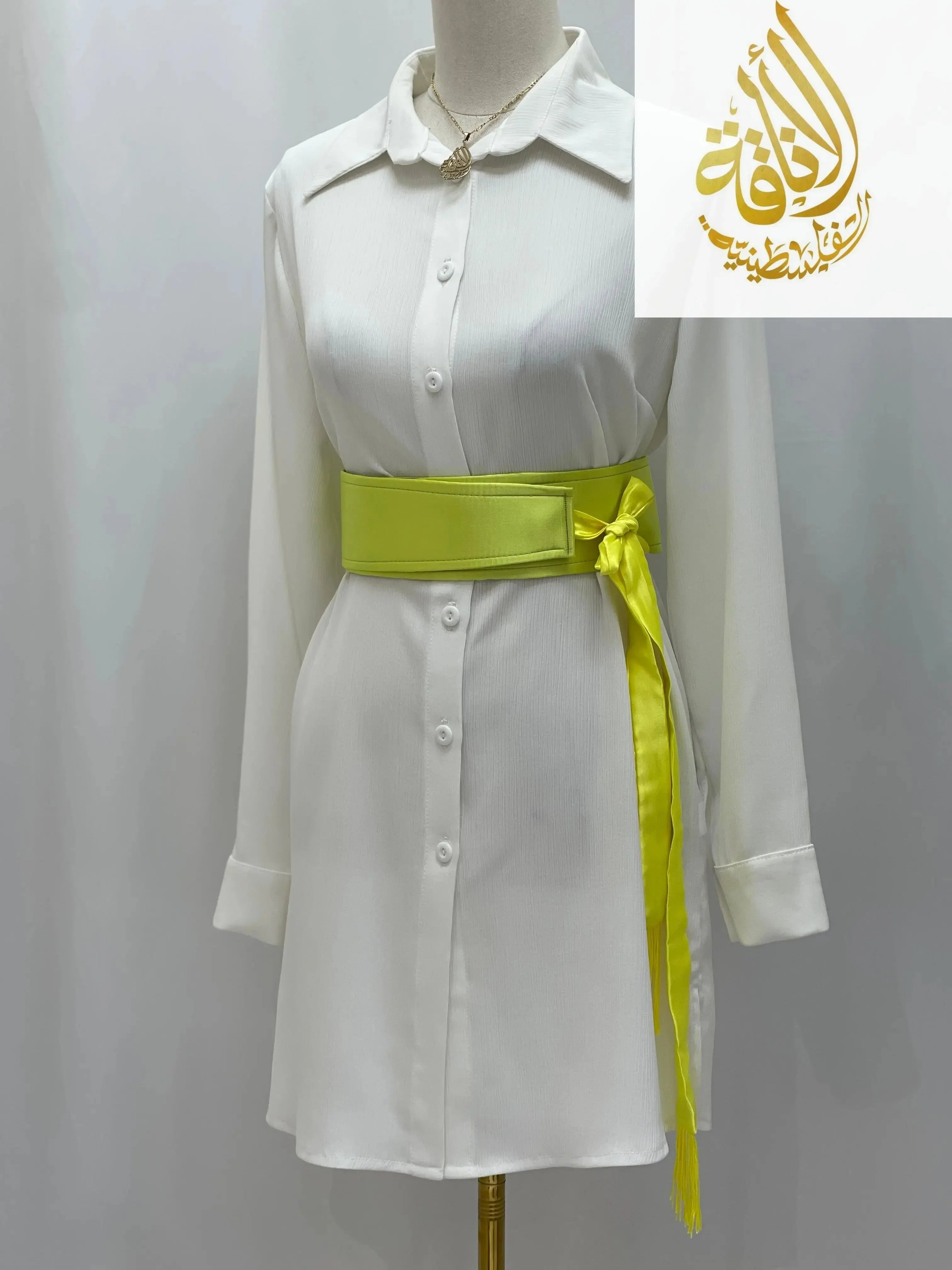 Yellow satin belt for dresses styled on a white button-down shirt dress by Palestinian Elegance