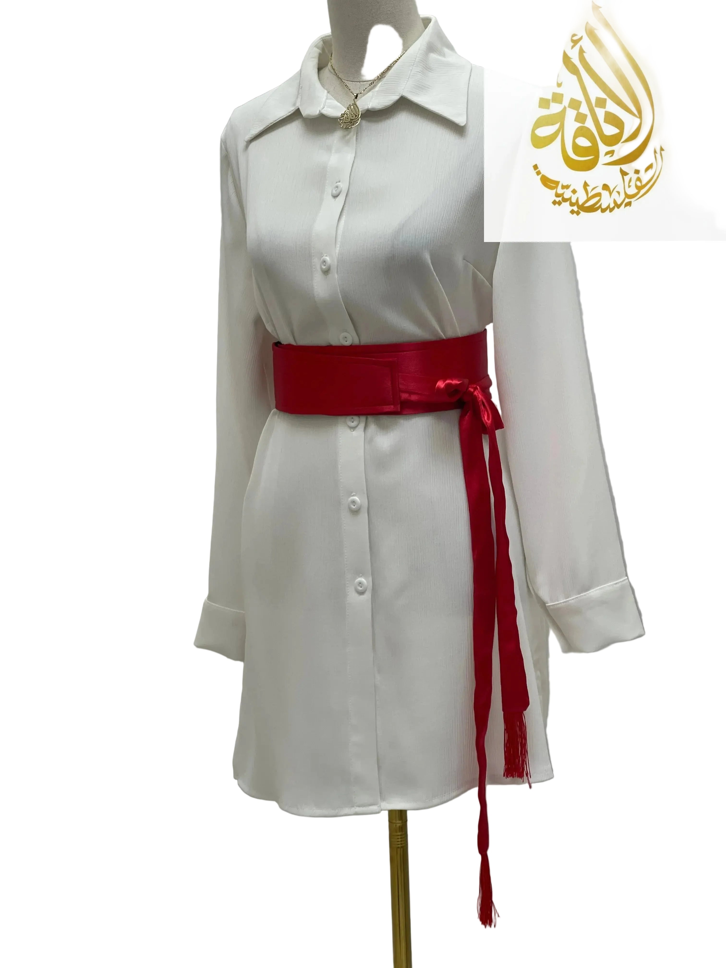 Red satin belt for dresses tied around waist of white button-down dress by Palestinian Elegance