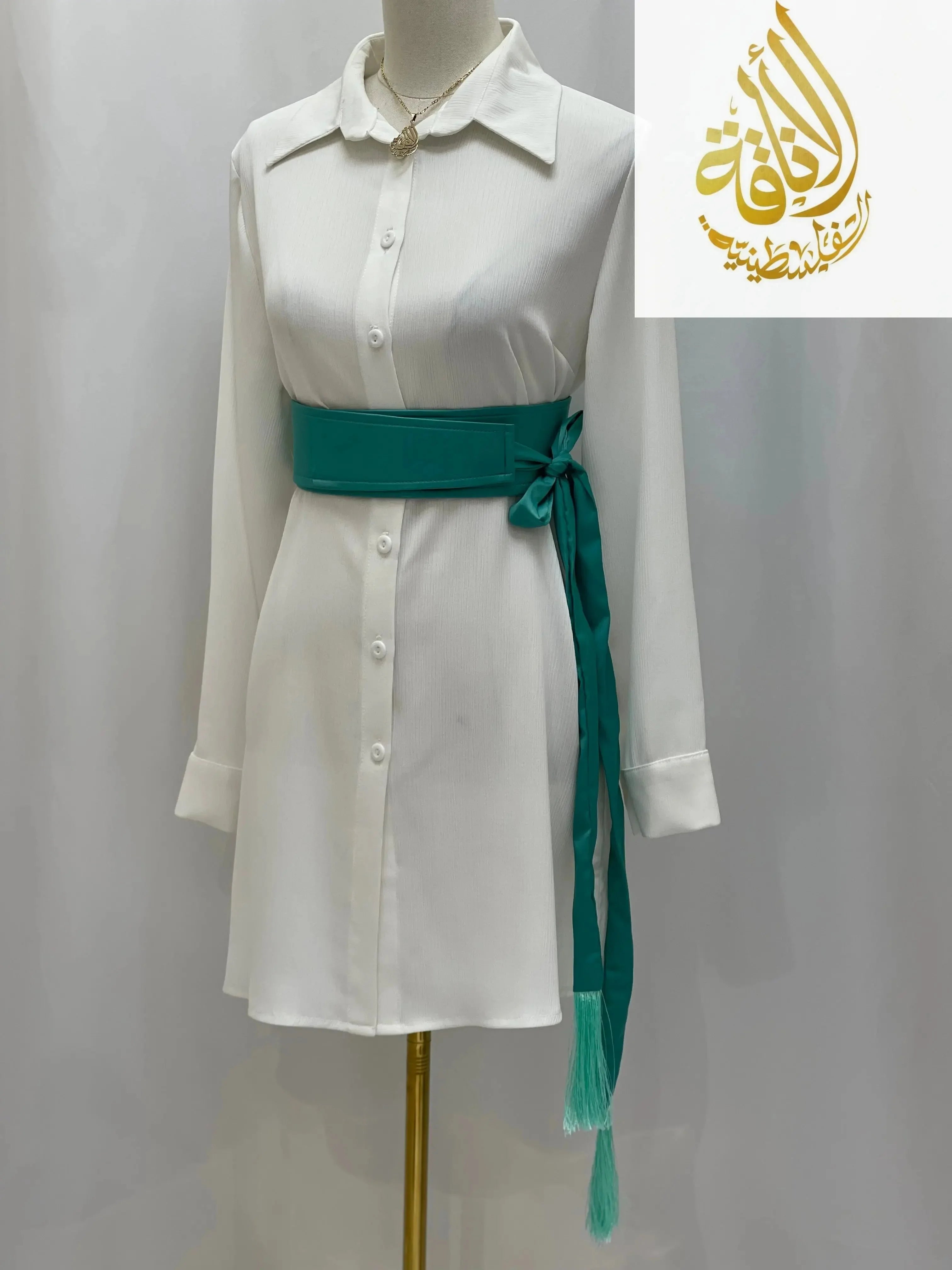 Satin belt for dresses in teal tied around white button-down dress on mannequin