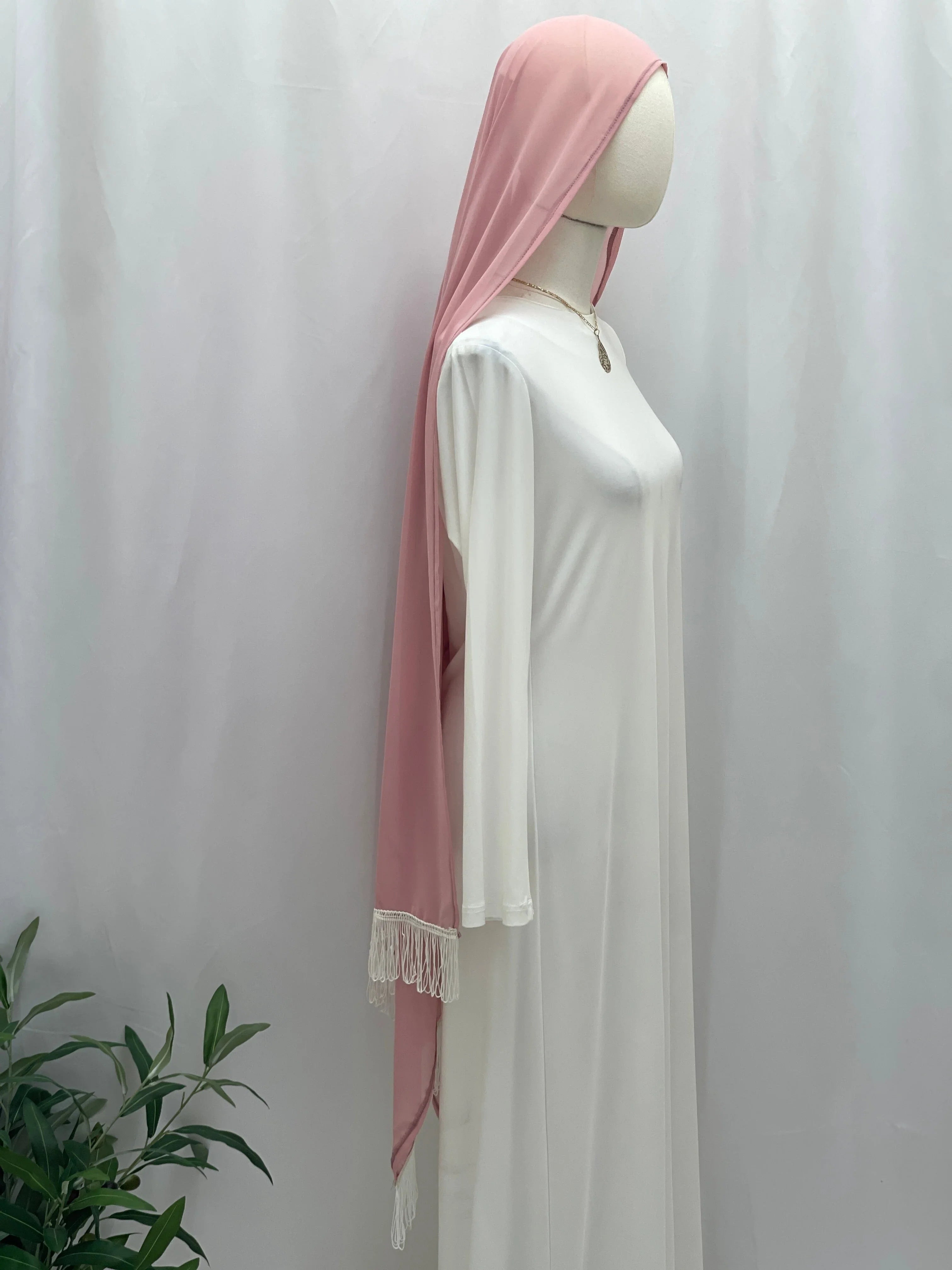 New Khirka With White tassel pink khimar draped on mannequin wearing white abaya by Palestinian Elegance