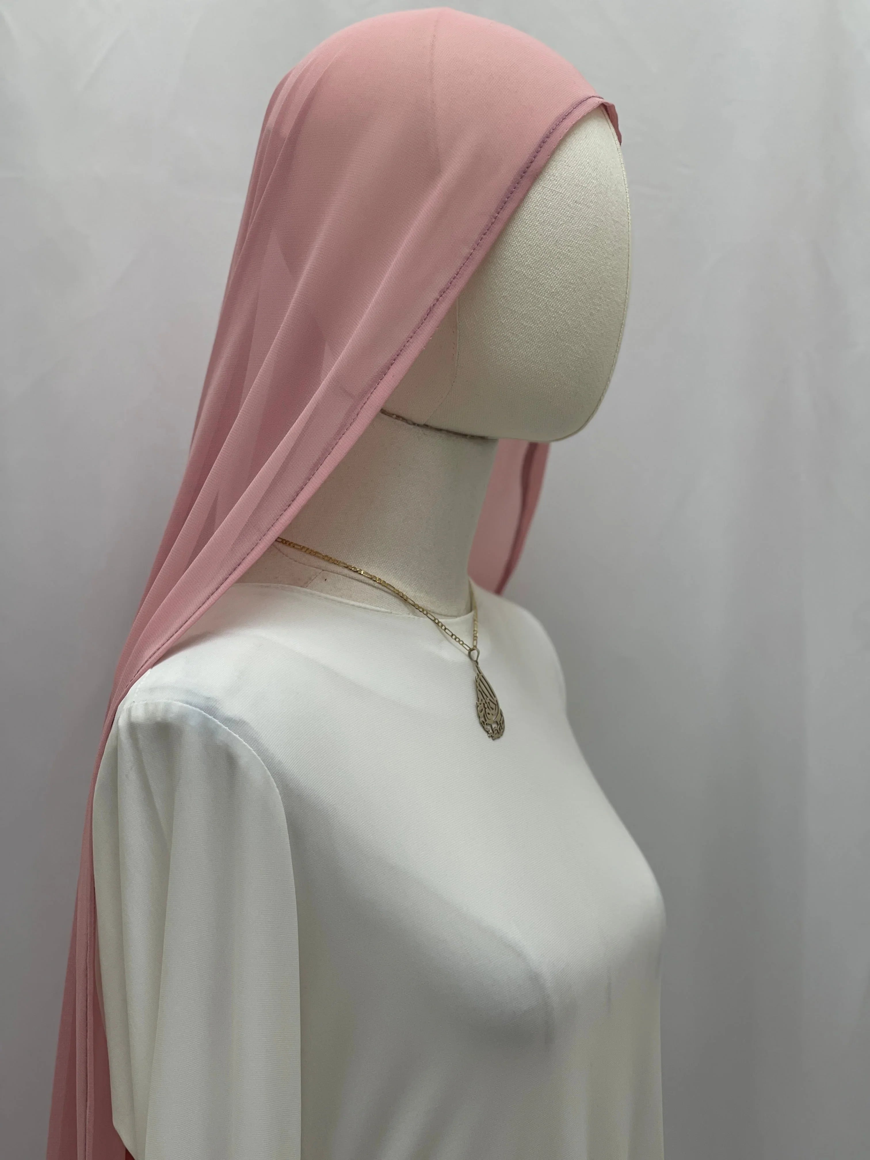 New Khirka With White tassel Palestinian Elegance pink khirka draped on mannequin over white dress with pendant