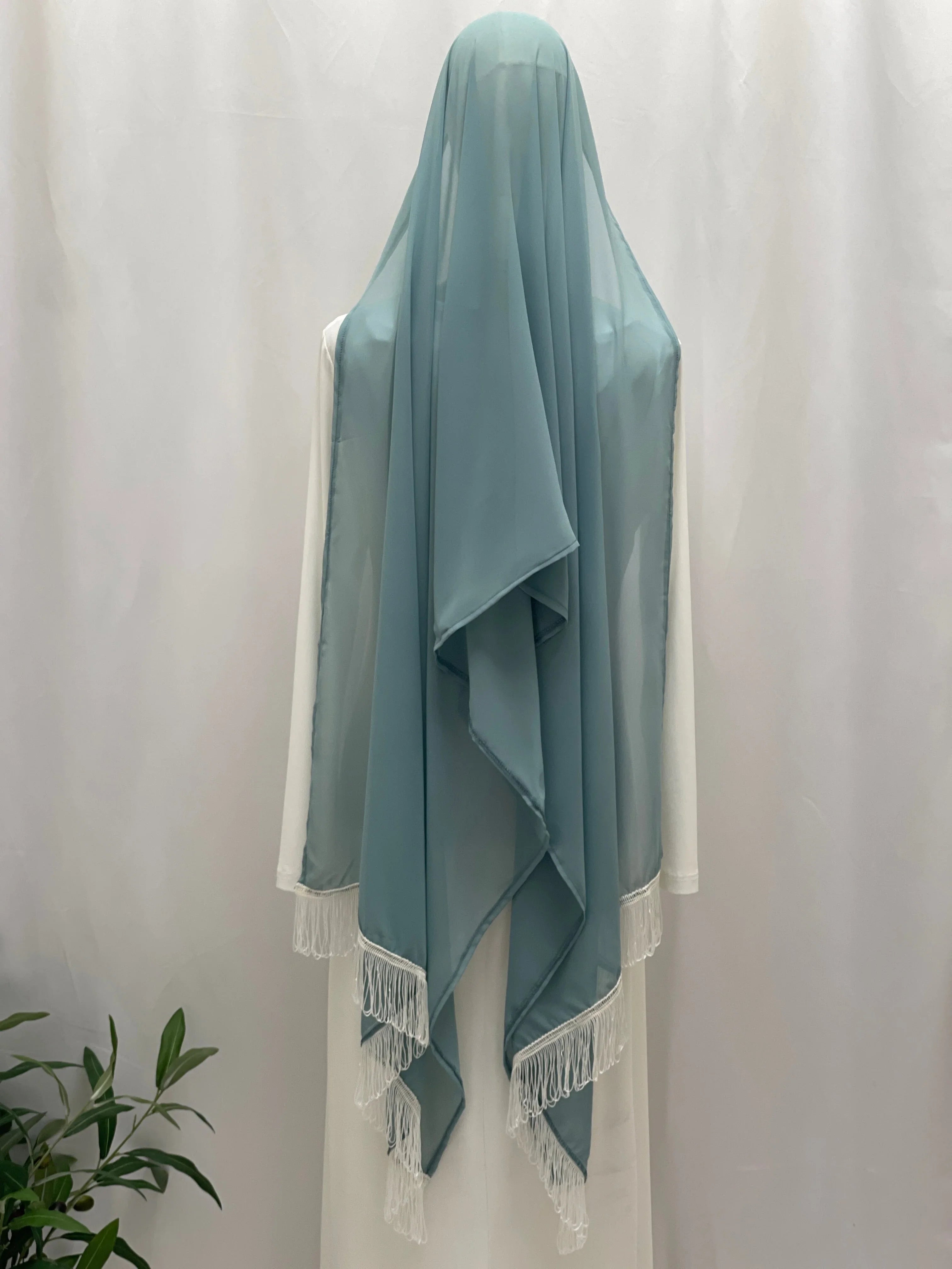 New Khirka With White tassel by Palestinian Elegance teal chiffon khirka back view draped on mannequin with fringe
