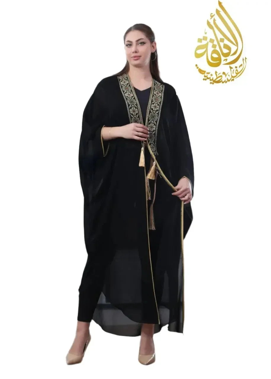 Palestinian Elegance black embroidered chiffon cardigan with gold trim and tassel belt on woman